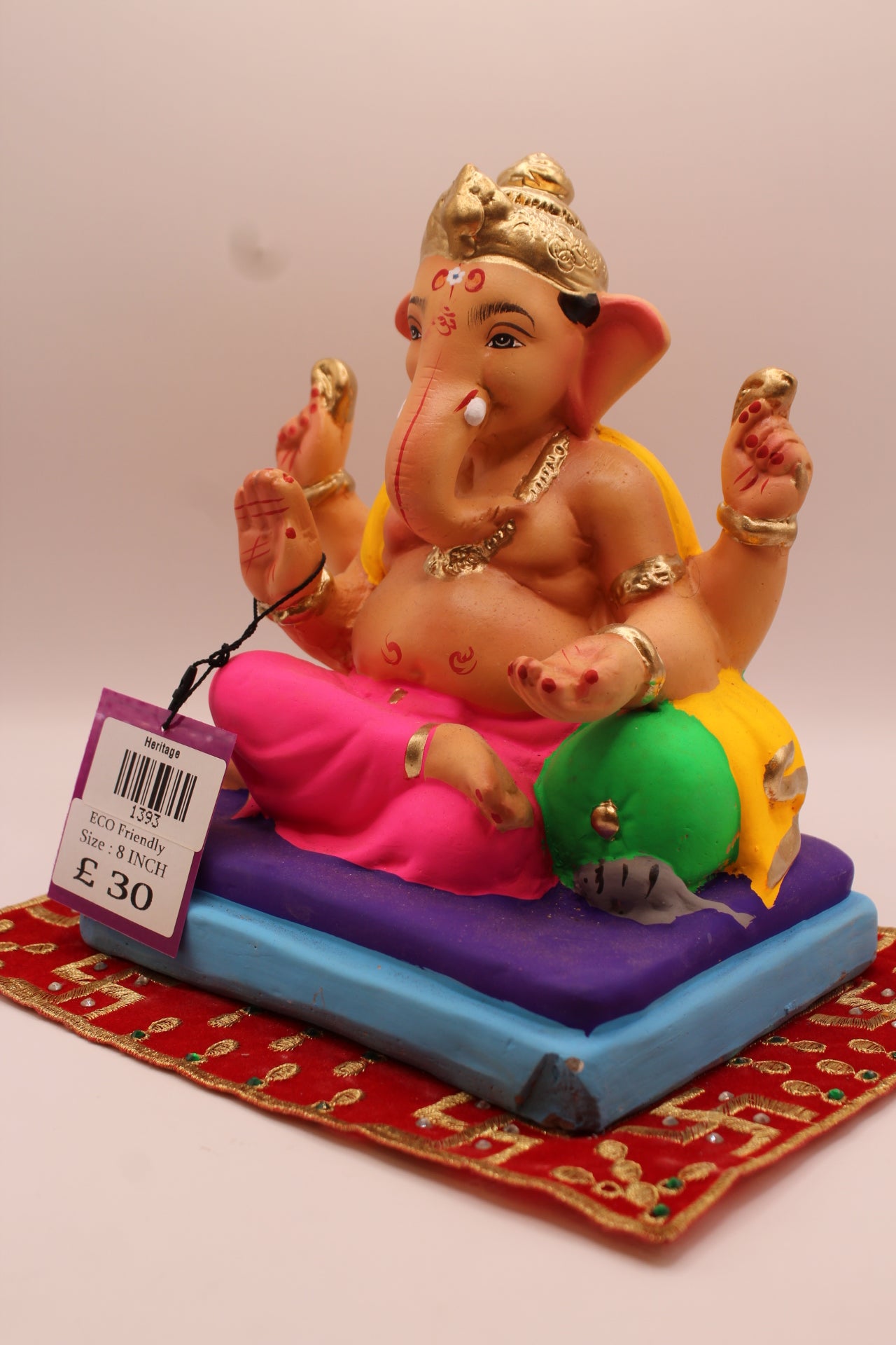 Angled view – yellow khes and pink dhoti reclining on a purple mat
