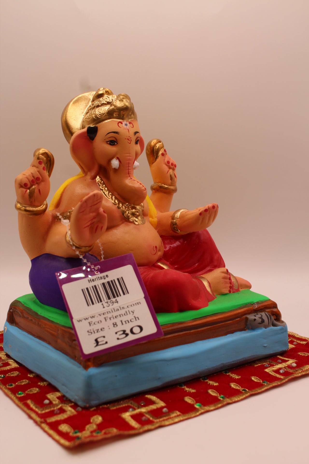Side view – yellow khes and red dhoti reclining against a purple bolster