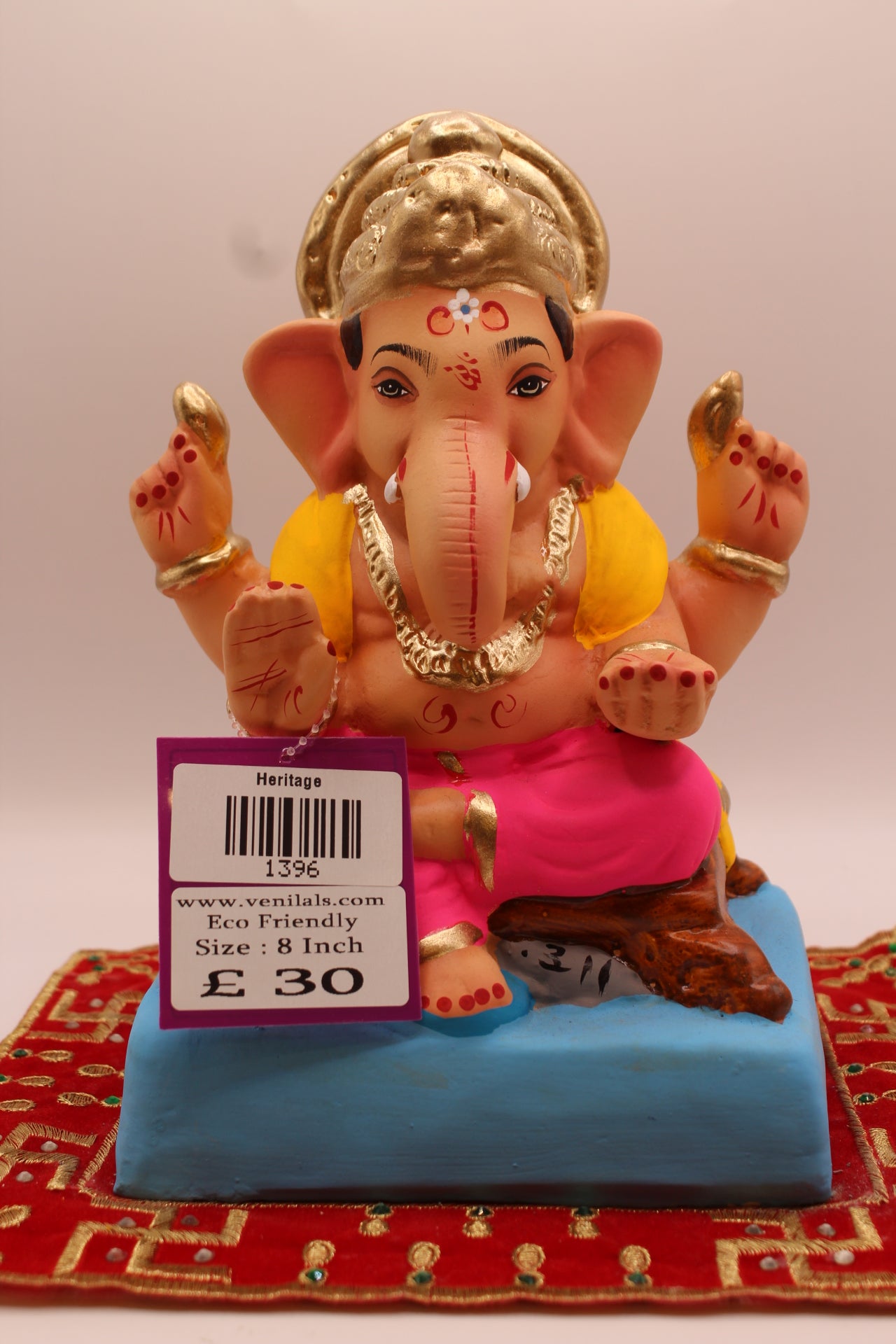 8 inch eco-friendly Ganesh idol – yellow khes and pink dhoti seated on a wooden chowki, front