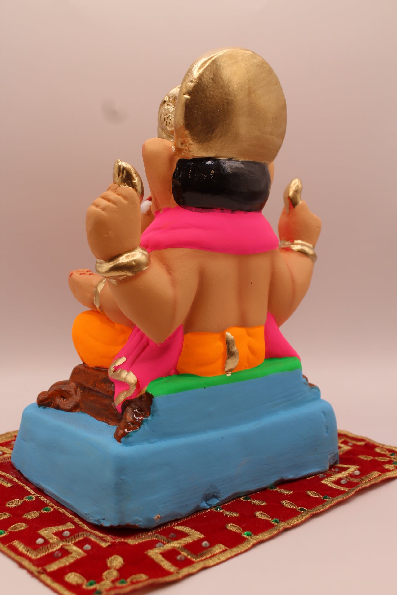 Back view – pink khes and orange dhoti with gold halo crown