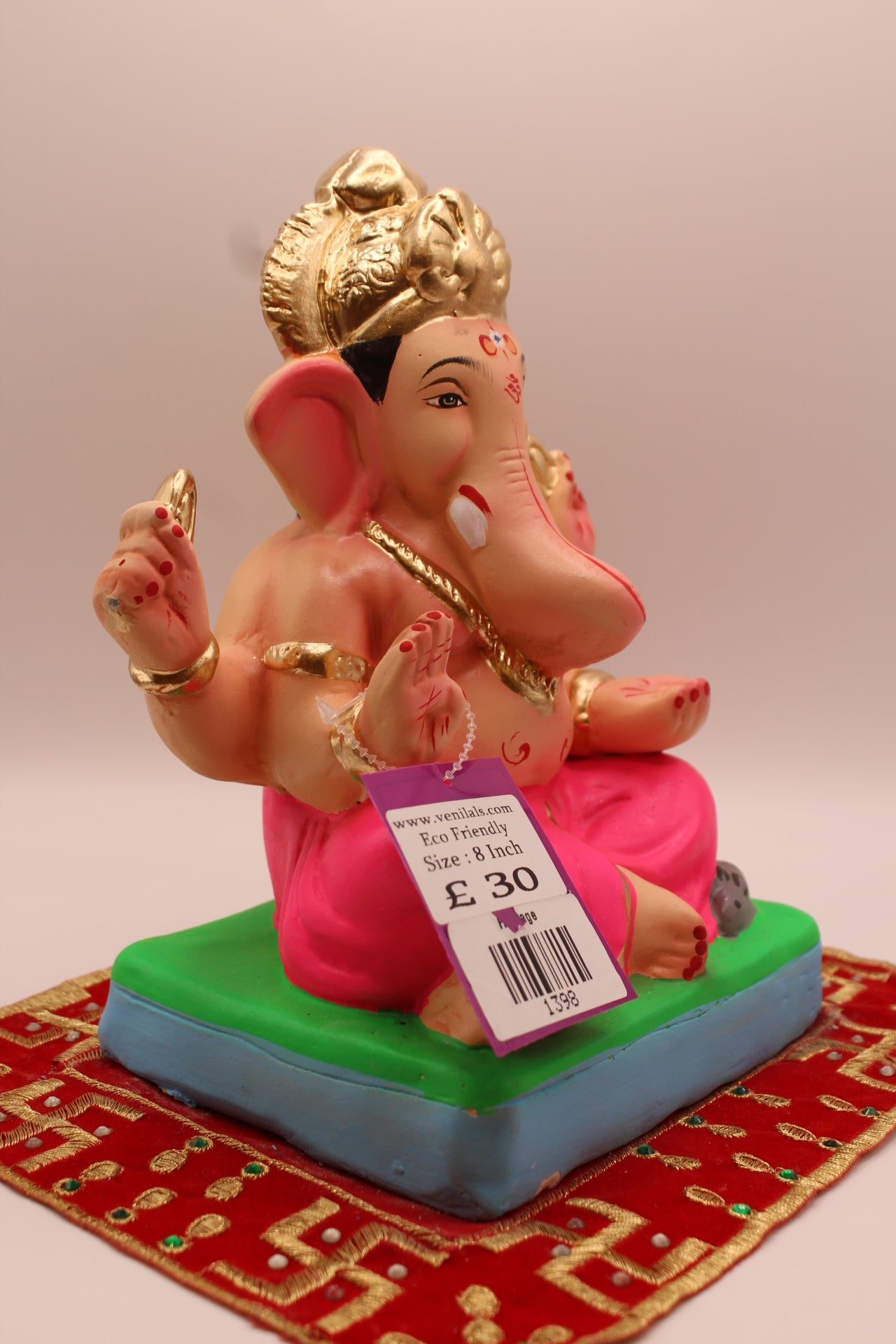 Side view – all rani pink outfit with tall carved gold mukut