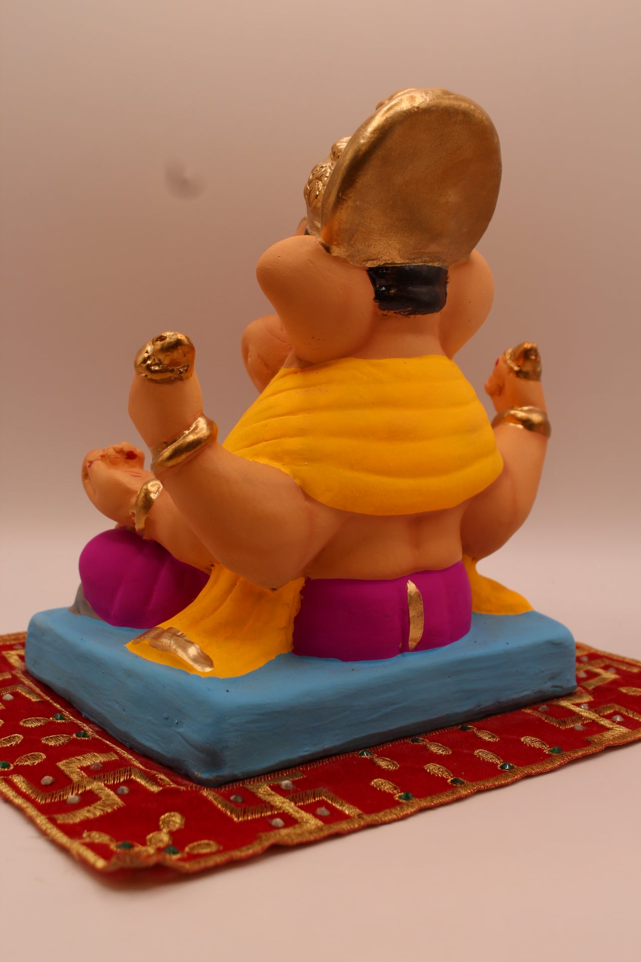 Back view – yellow khes and magenta dhoti in leaning pose