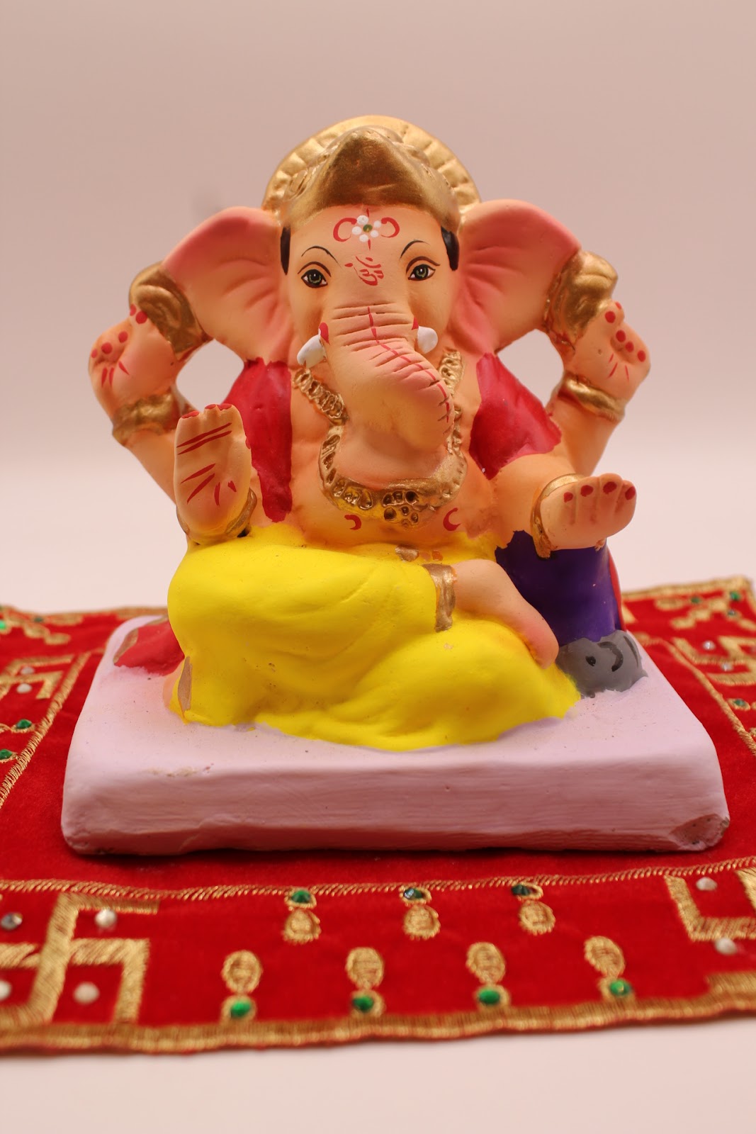 Eco-friendly 6 inch Ganesh idol, rose khes and yellow dhoti, front view