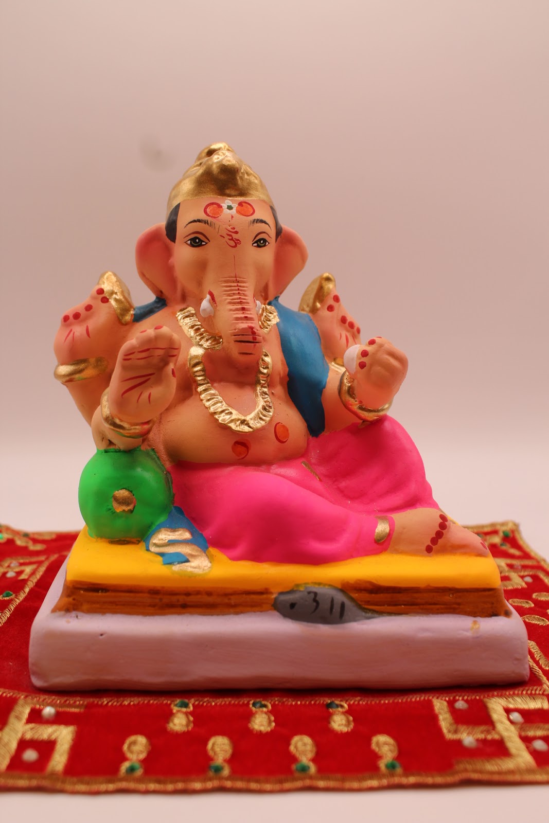 Eco-friendly 6 inch Ganesh idol, blue khes and rani pink dhoti, front view