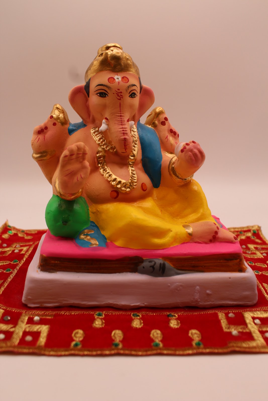 Eco-friendly 6 inch Ganesh idol, blue khes and yellow dhoti, front view