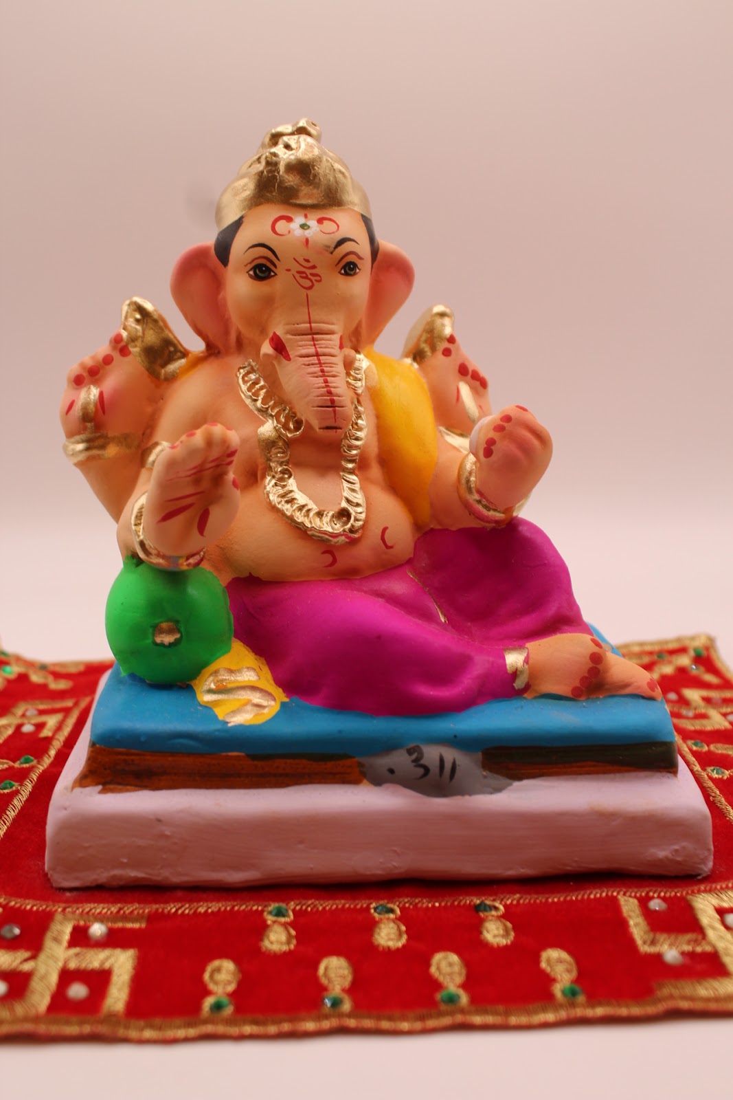 Eco-friendly 6 inch Ganesh idol, yellow khes and magenta dhoti, front view