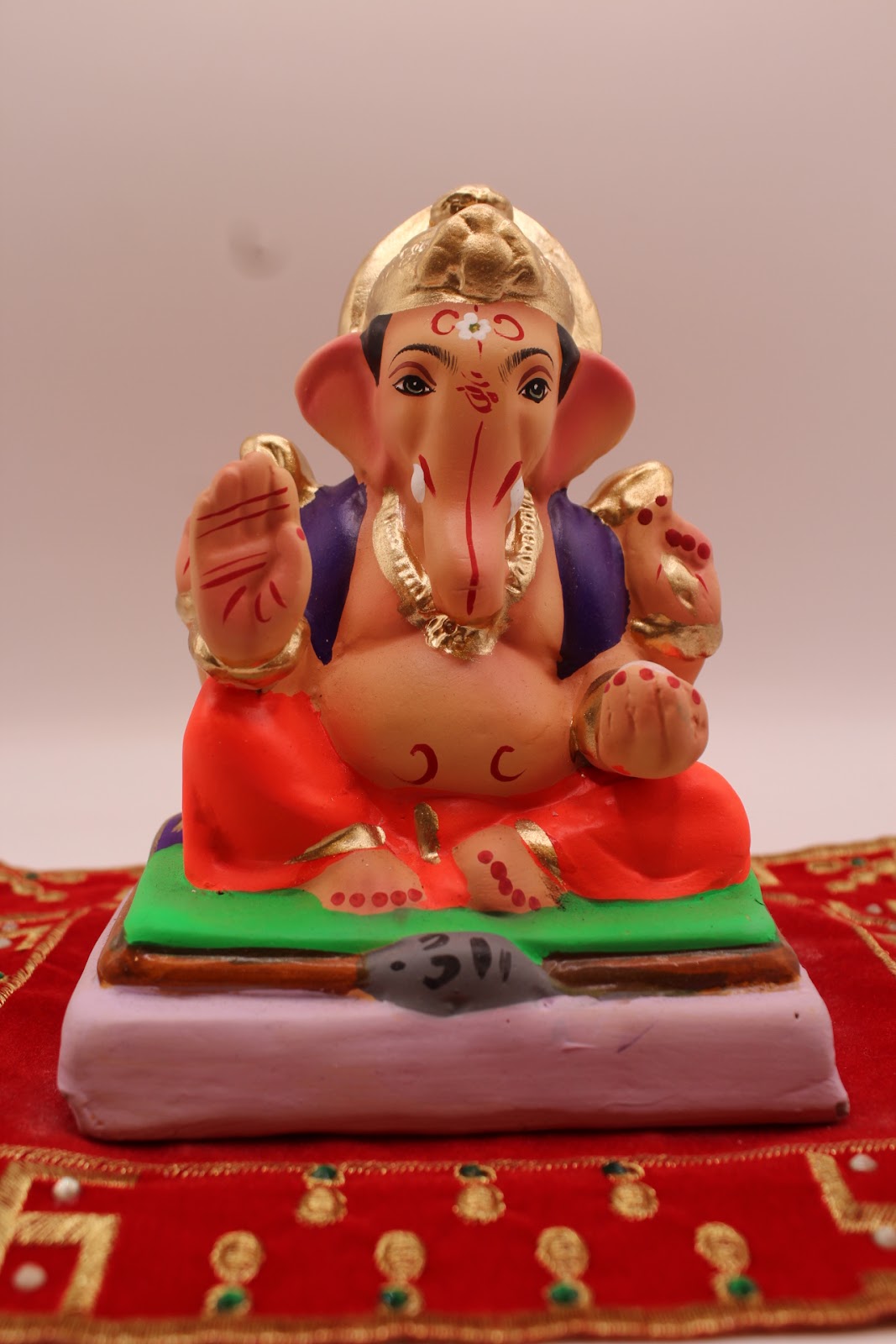Eco-friendly 6 inch Ganesh idol, purple khes and coral dhoti, front view