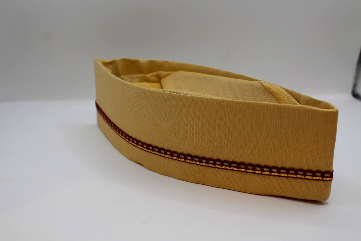 Champagne gold Gandhi topi with maroon border, angled view