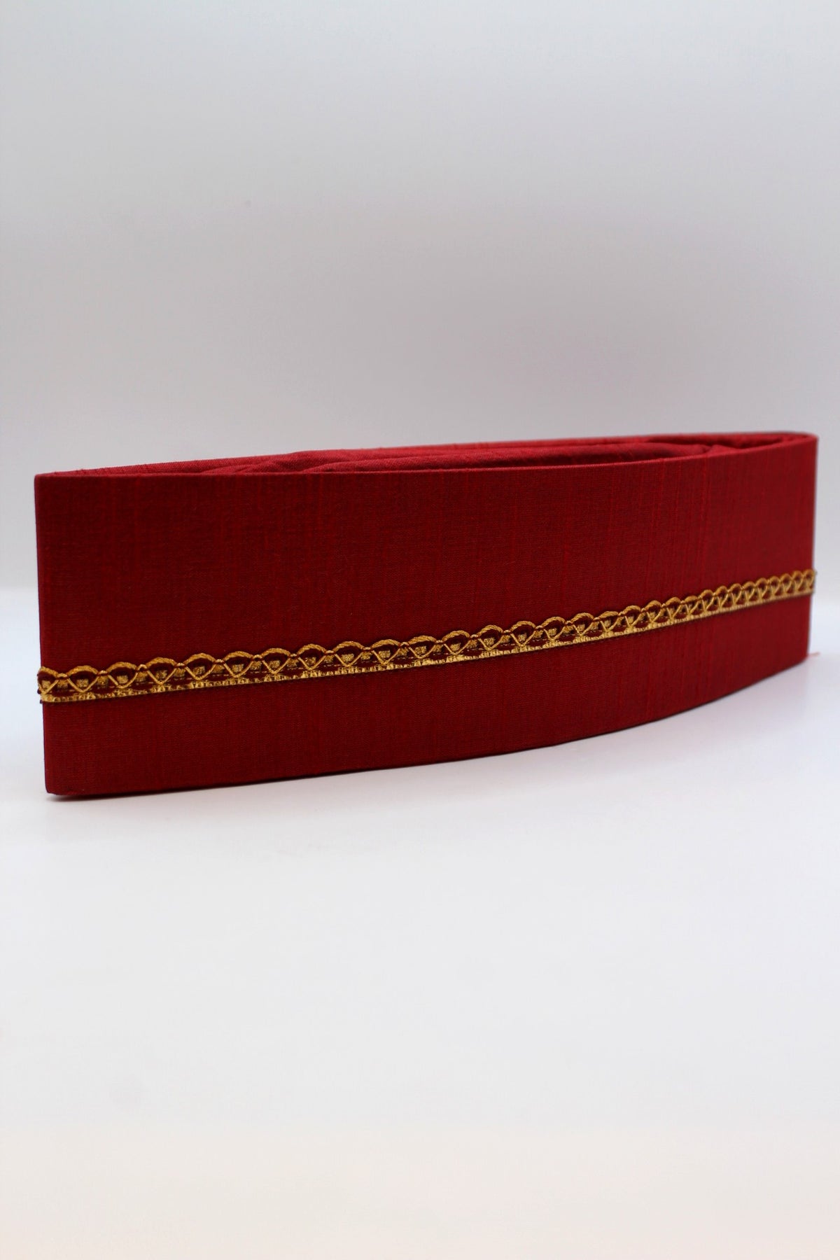 Maroon Gandhi topi with golden border, side view