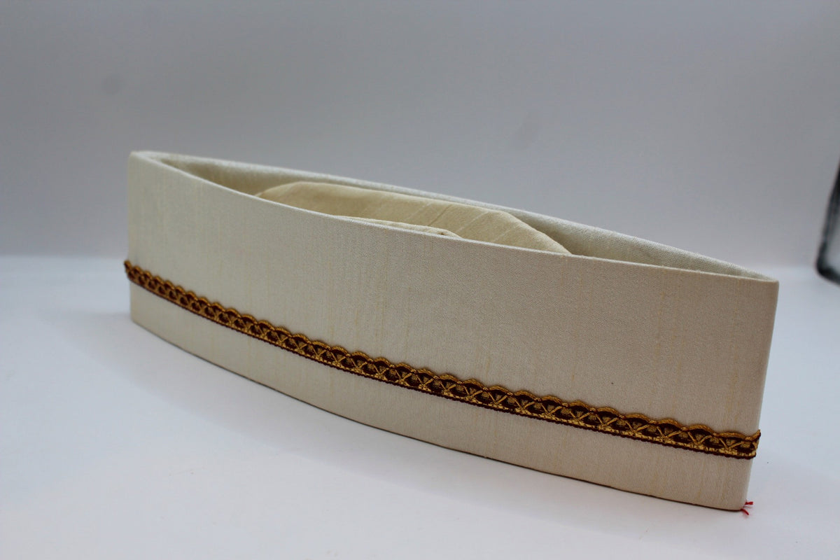 Off-white Gandhi topi with maroon and gold border, side view
