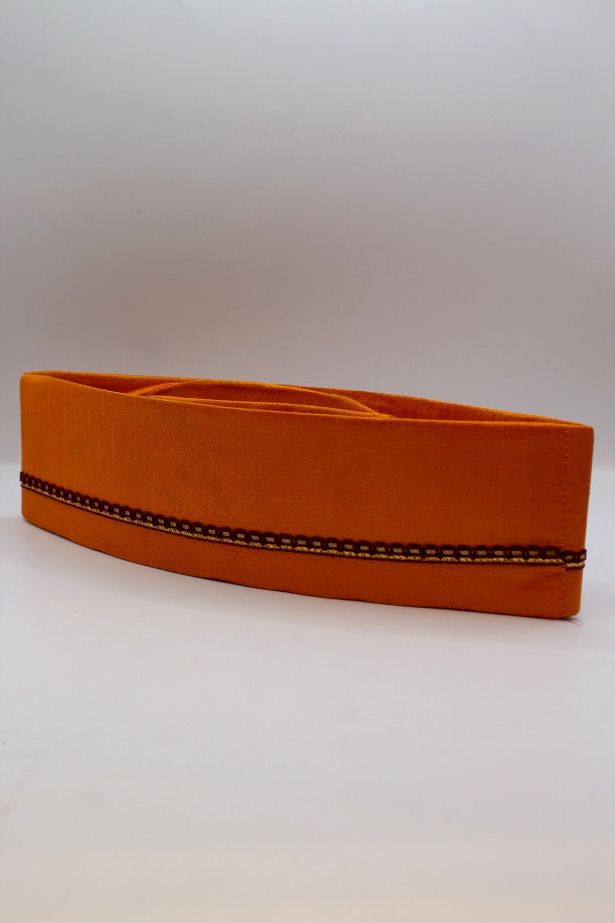 Saffron Gandhi topi with maroon border, angled view