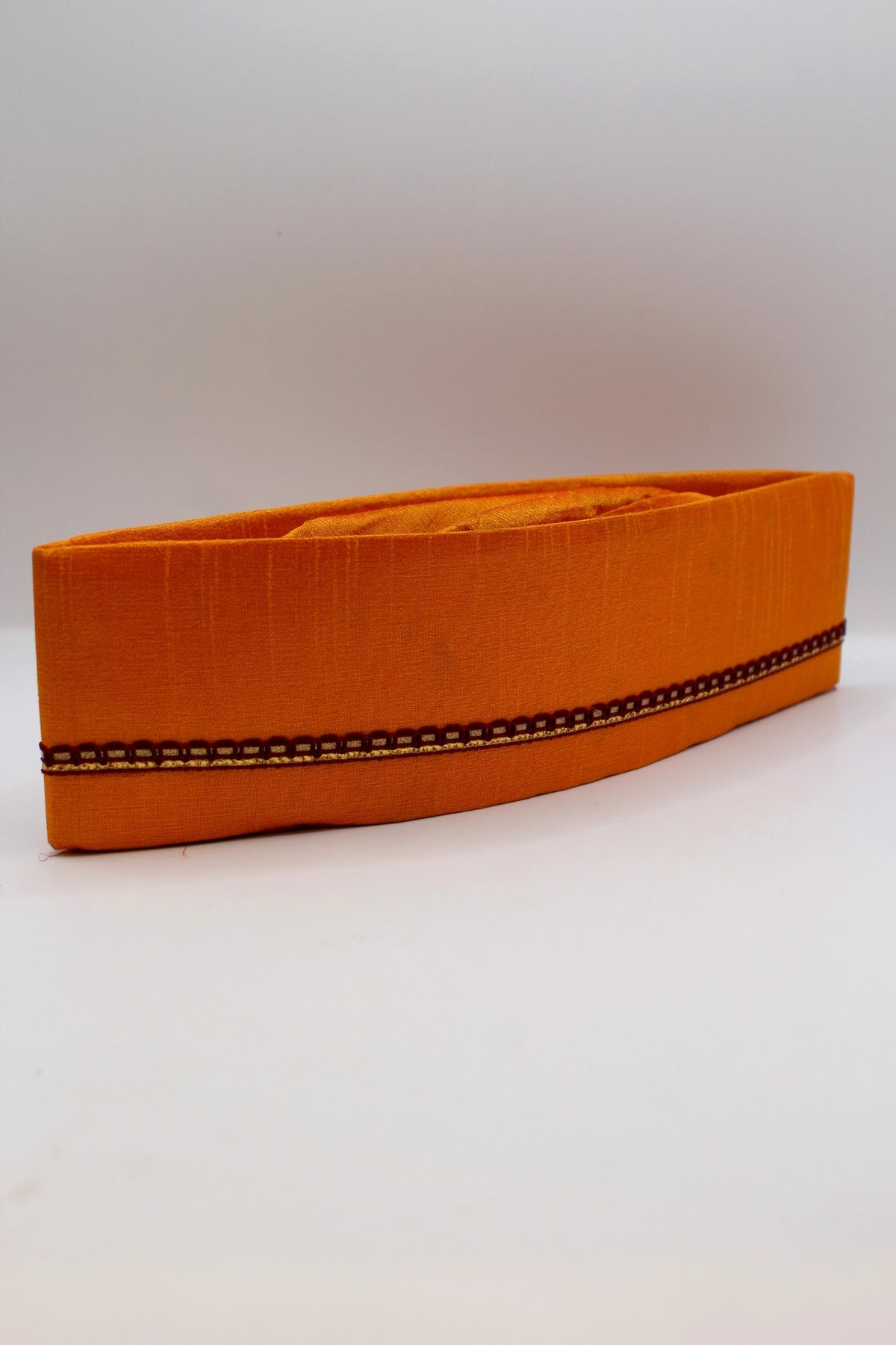 Saffron Gandhi topi with maroon border, side view