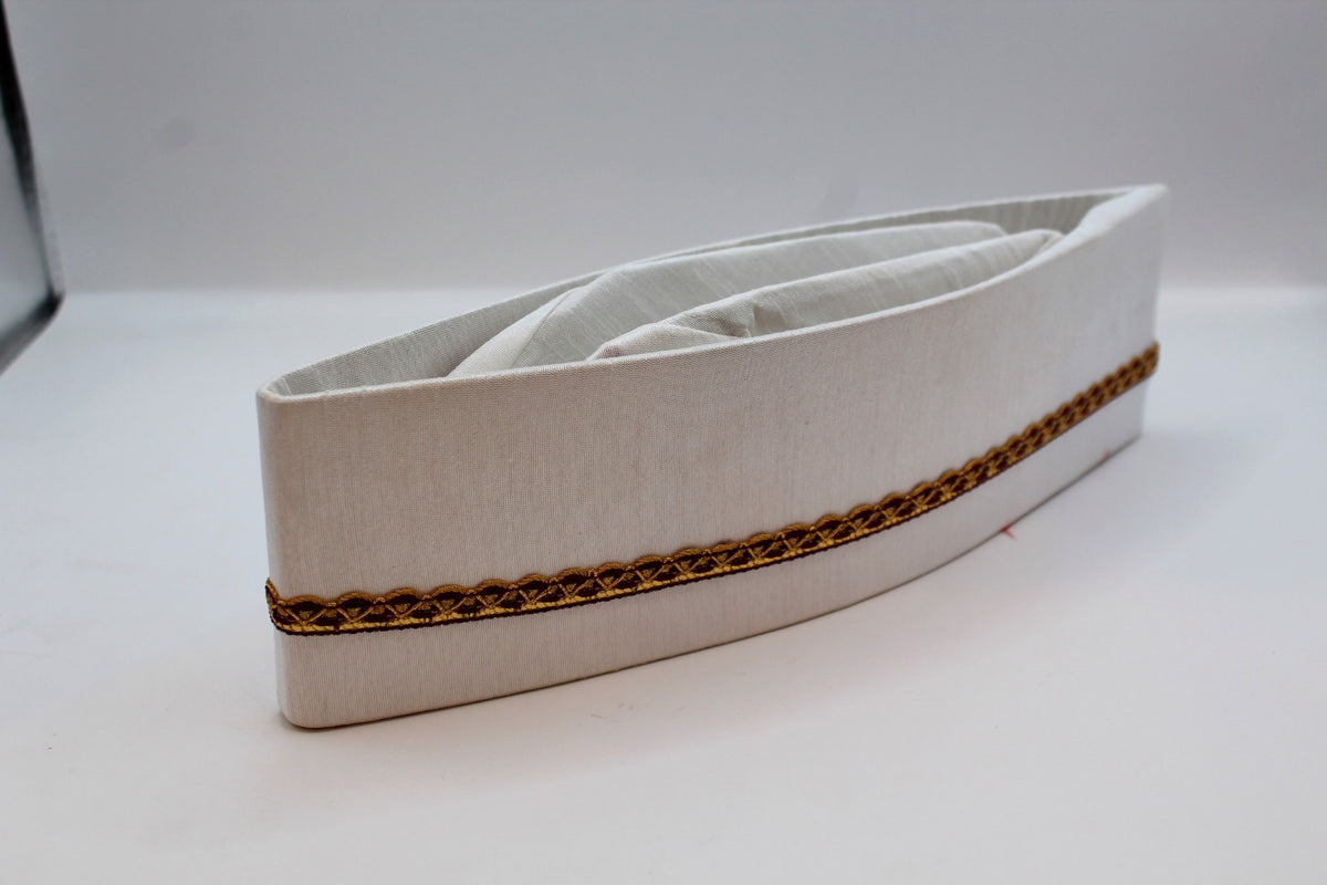 White Gandhi topi with maroon and gold border, side view