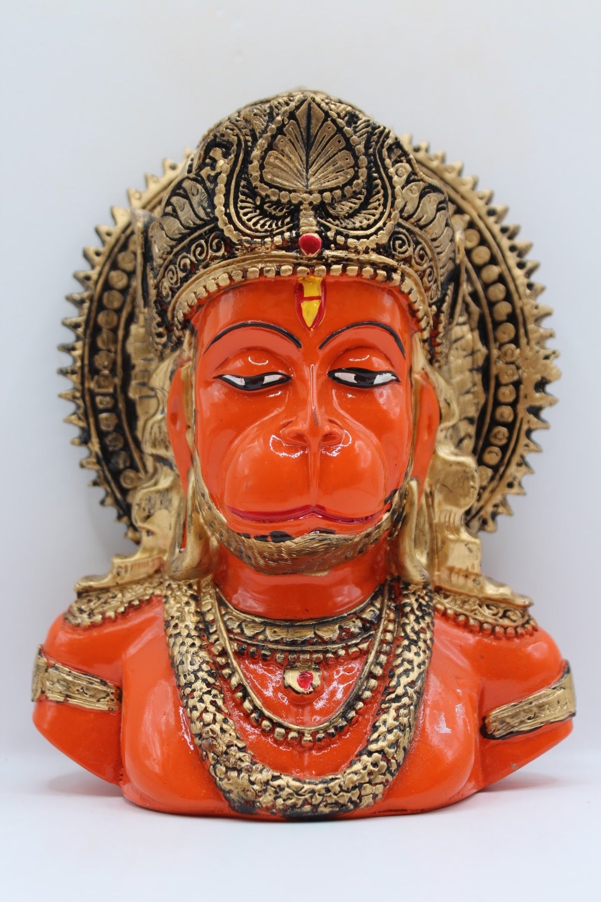 Orange resin Hanuman bust with gold crown, front view