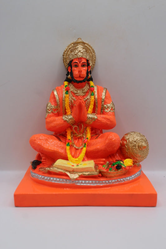 Orange resin Hanuman murti seated in prayer, front view