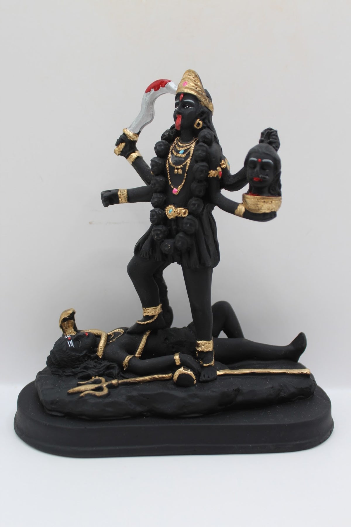 Black and gold resin Kali Mata murti standing on Shiva, front view