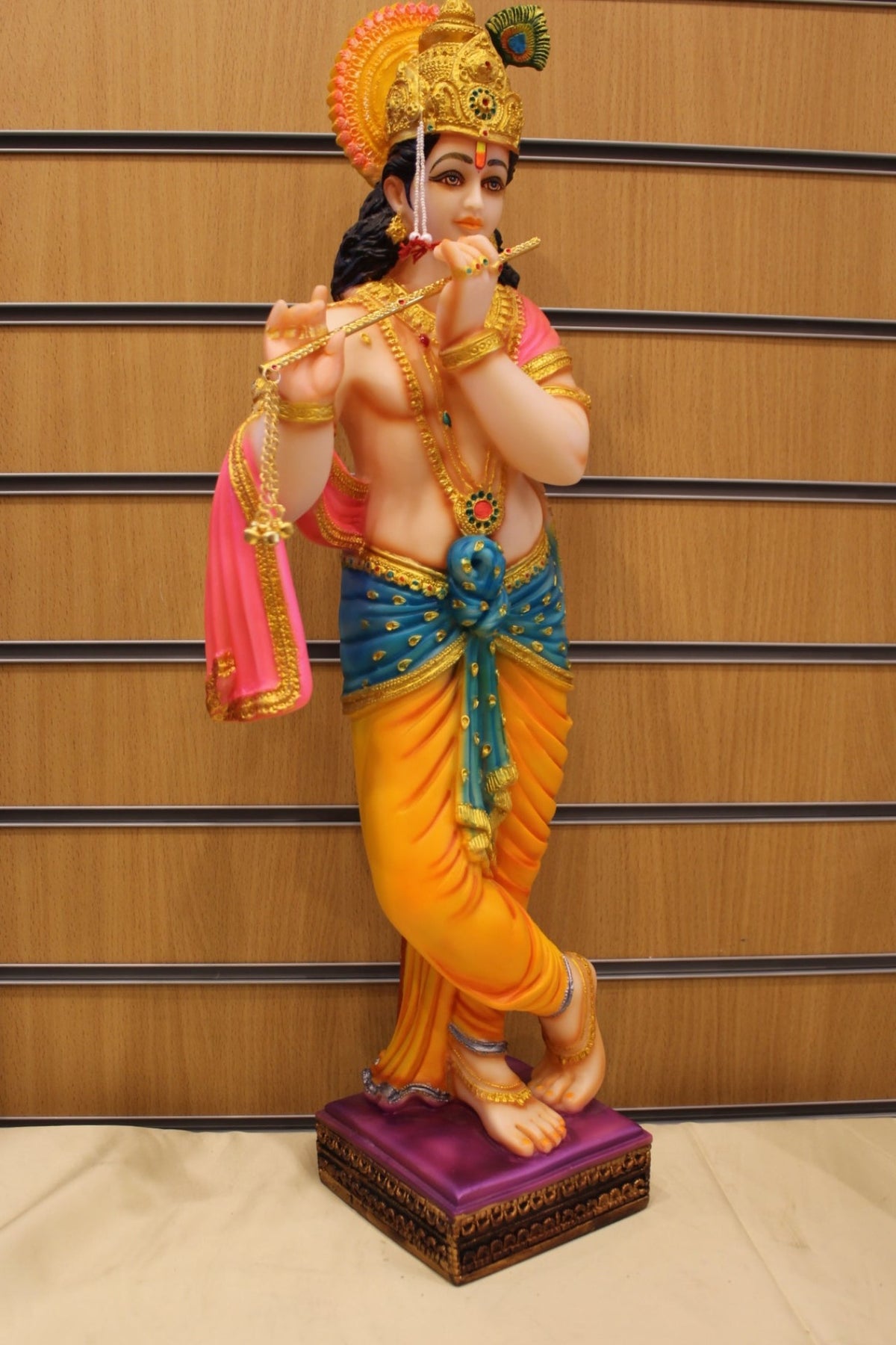 Resin/Fibre Krishna Statue for Home Temple – Playing Flute, 25 inch – Orange & Teal – left side view