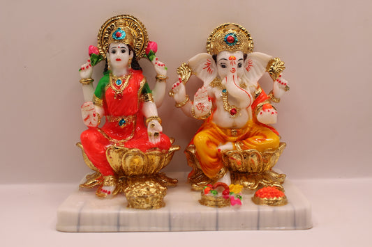 Resin Laxmi Ganesh murti pair on gold lotus seats with white base, front view