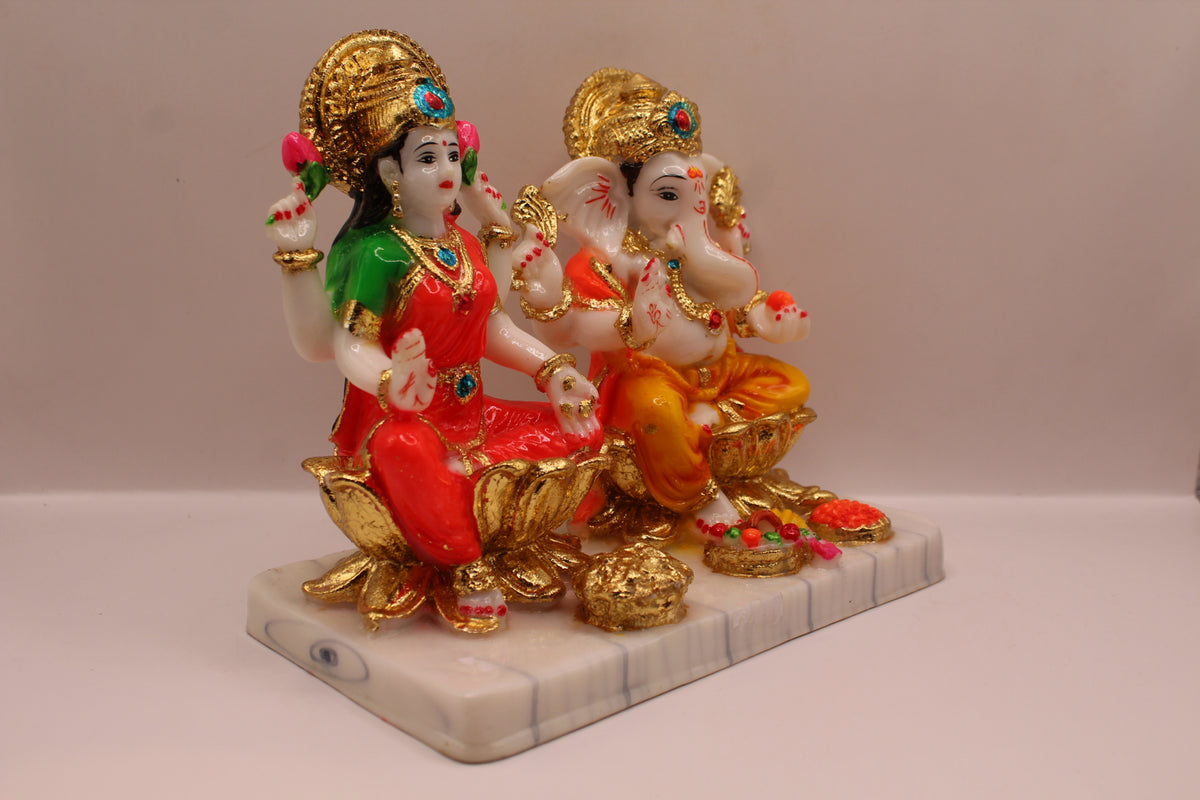 Resin Laxmi Ganesh murti pair on gold lotus seats with white base, left side view