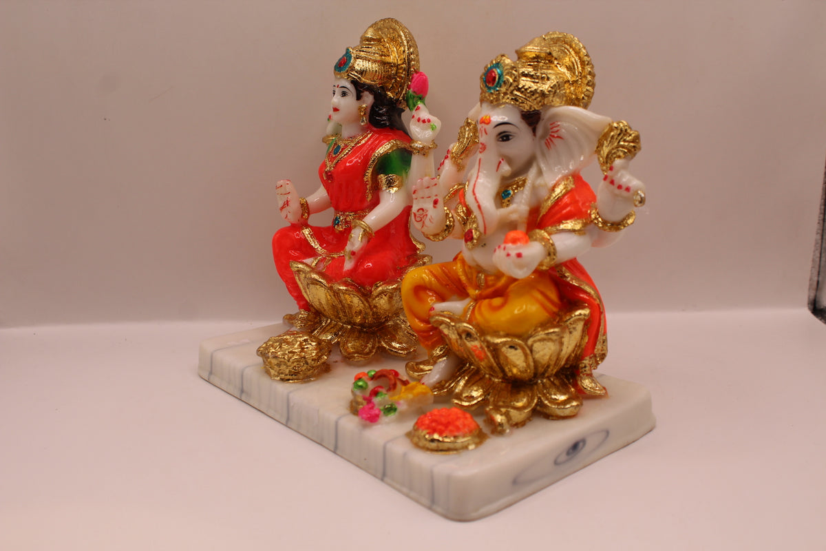 Resin Laxmi Ganesh murti pair on gold lotus seats with white base, right side view