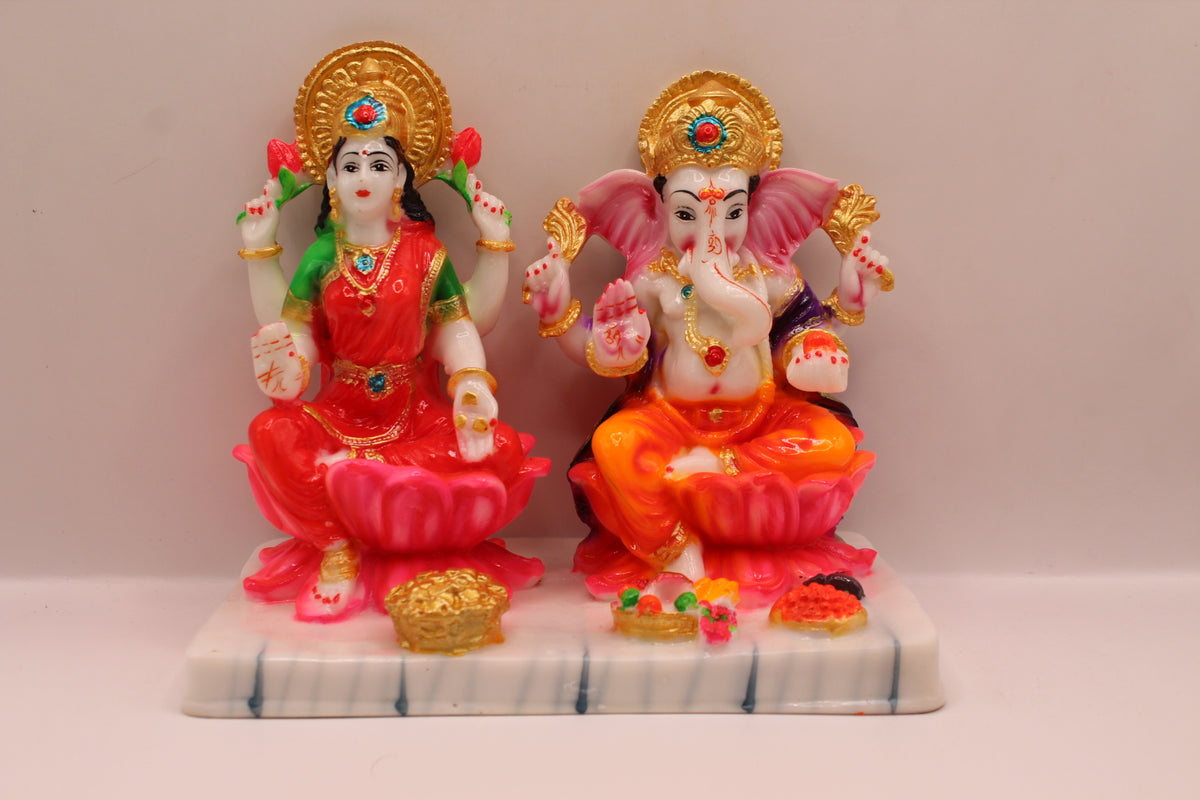 Resin Laxmi Ganesh murti pair on lotus seats with white base, front view