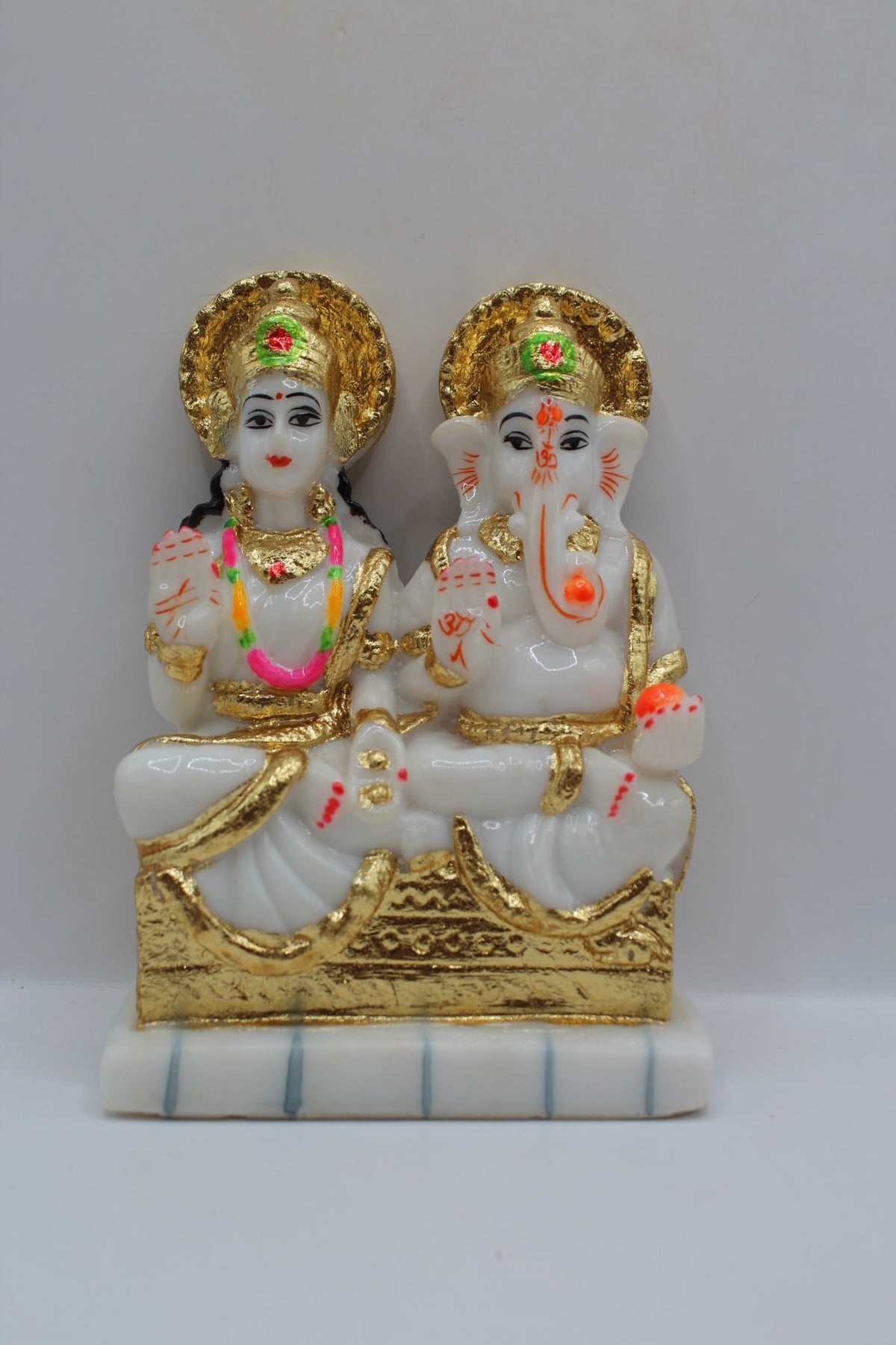 White and gold resin Laxmi Ganesh murti pair, front view