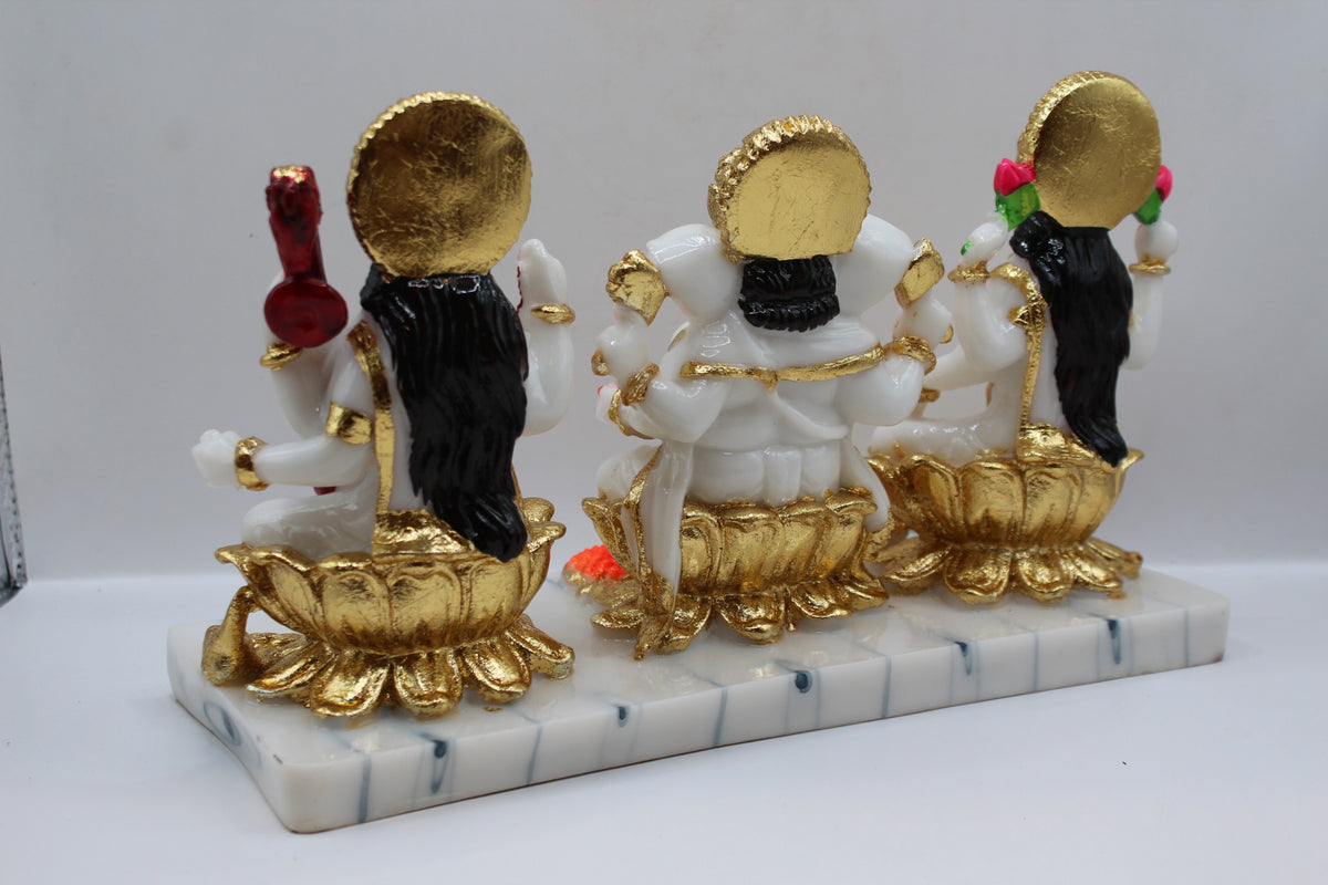 White and gold resin Laxmi Ganesh Saraswati murti trio, back view