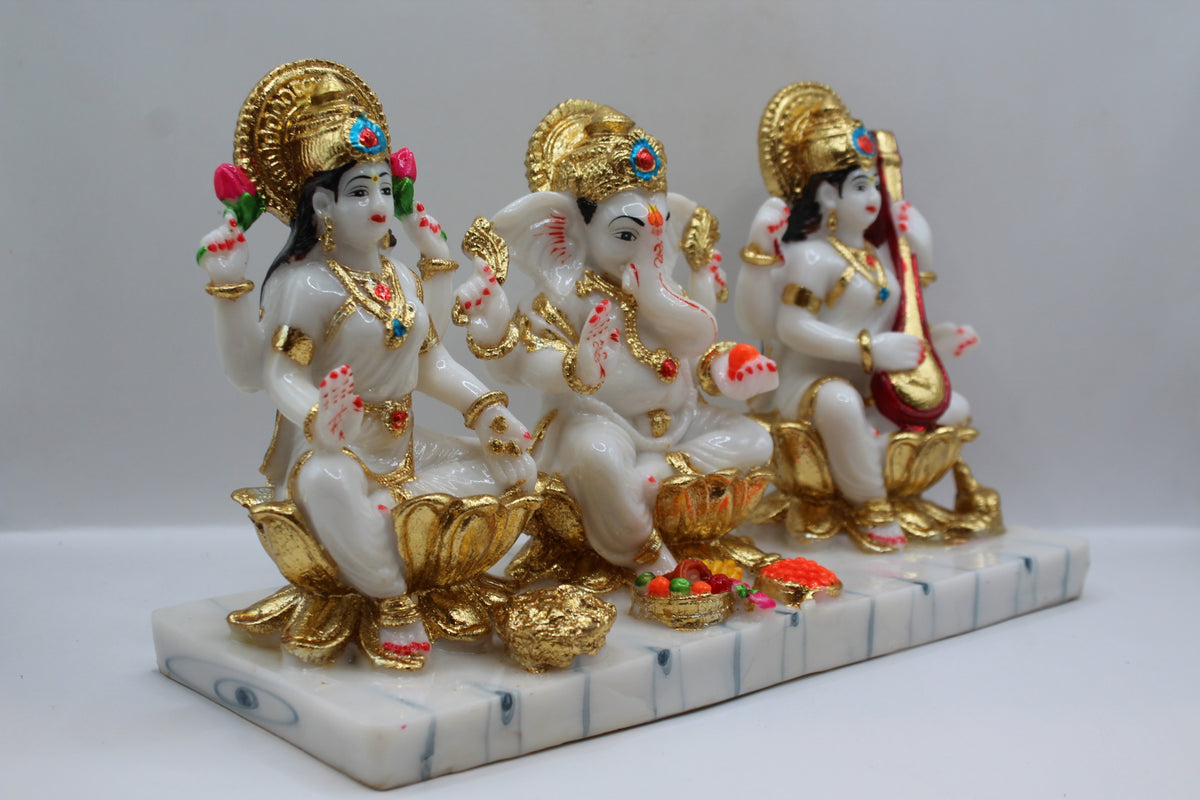 White and gold resin Laxmi Ganesh Saraswati murti trio, left side view