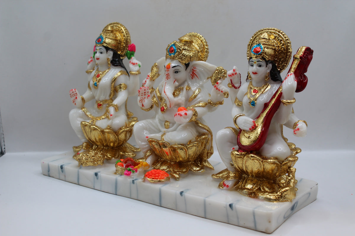 White and gold resin Laxmi Ganesh Saraswati murti trio, right side view
