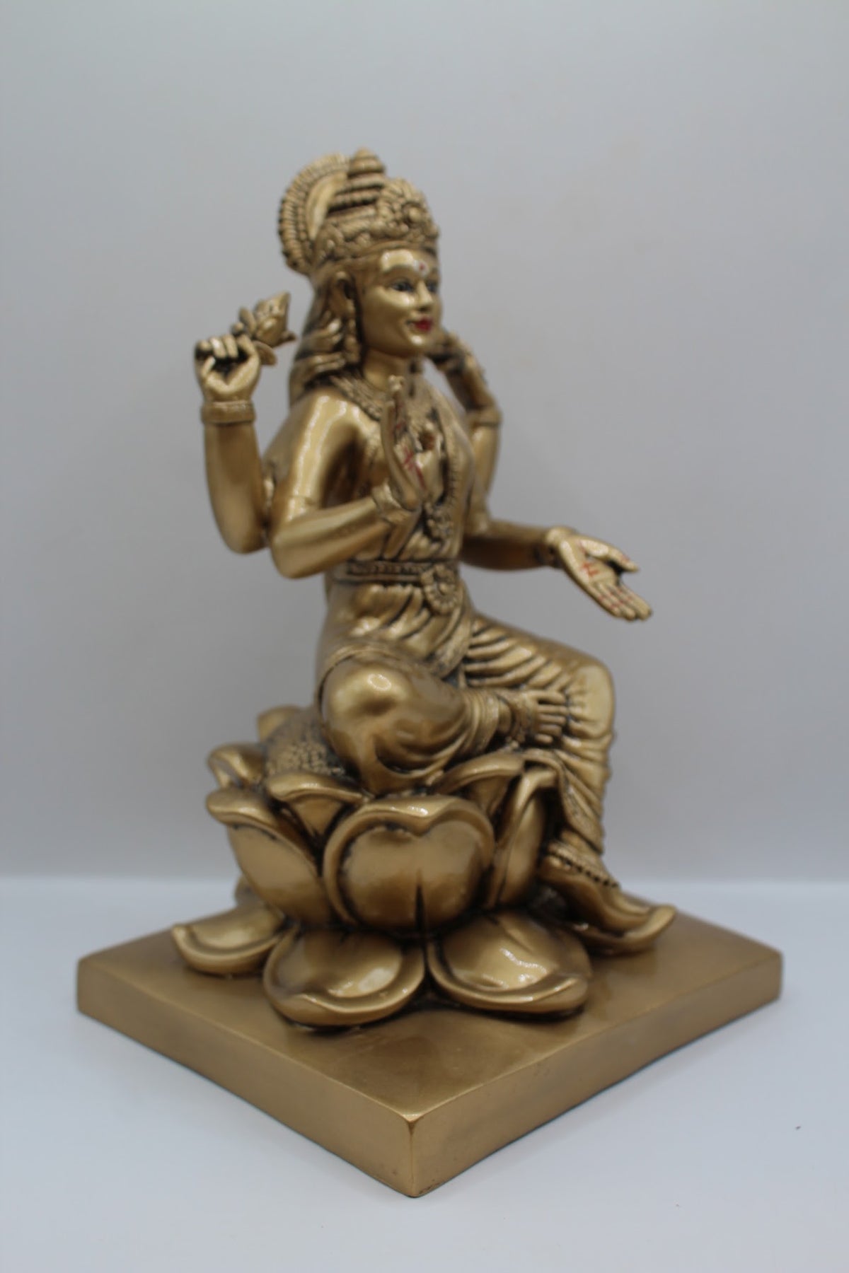 Antique gold resin Laxmi murti on a lotus, left side view