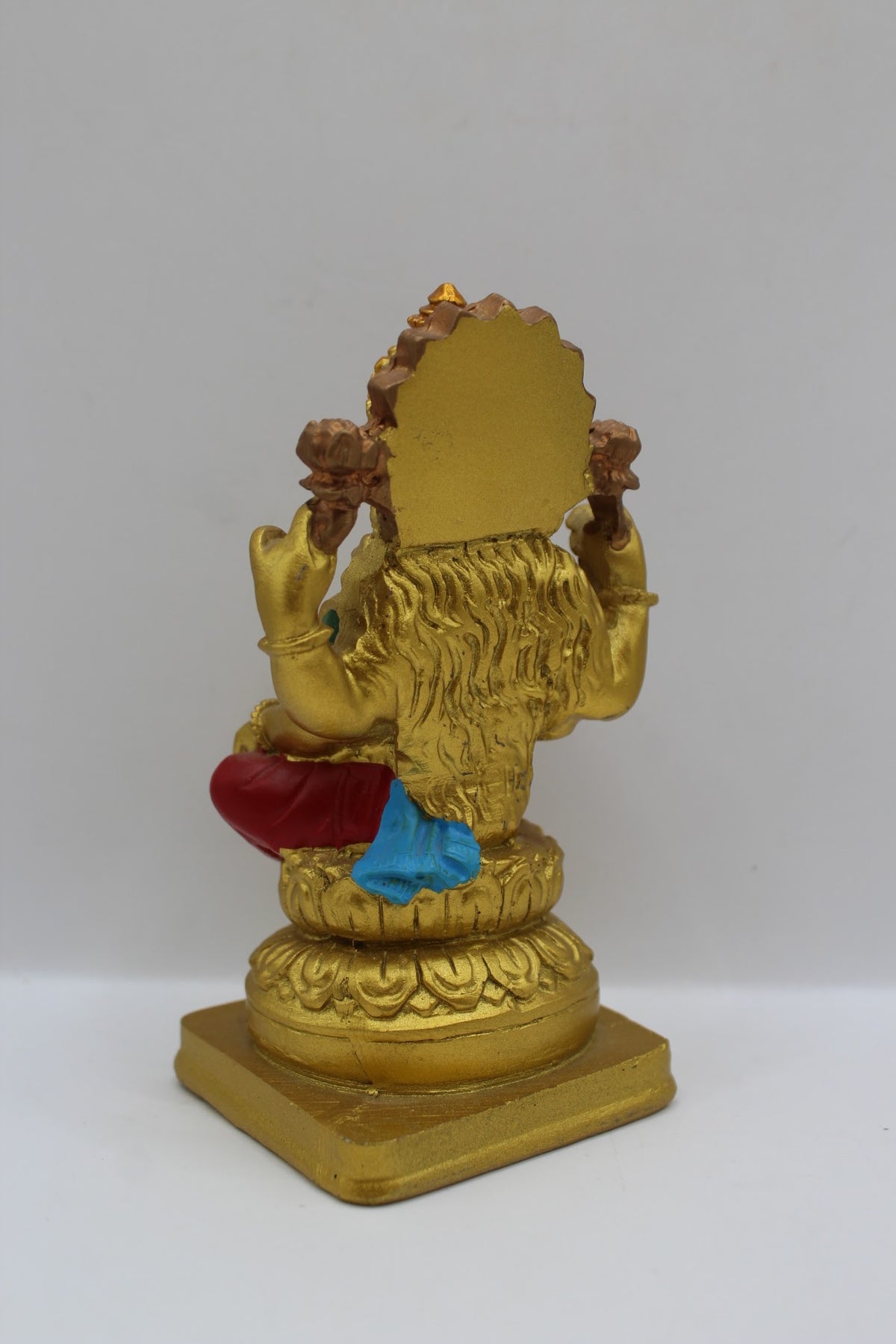 Small gold resin Laxmi murti with red clothes, back view