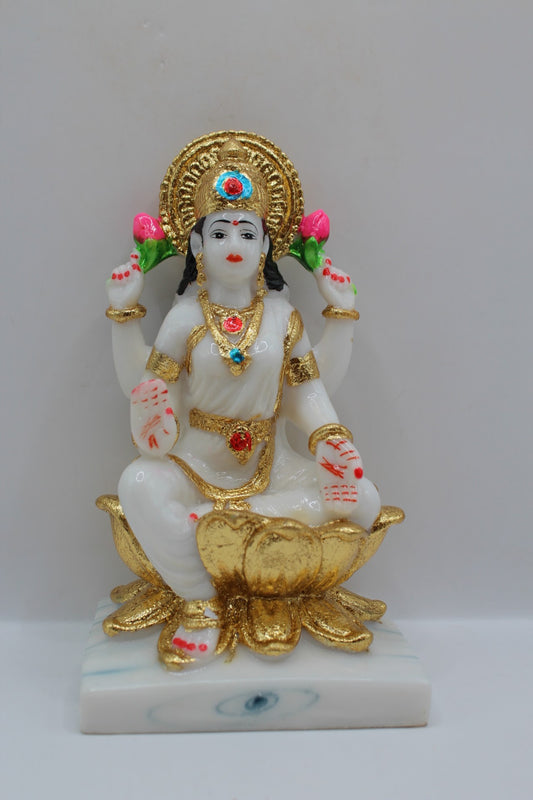 White and gold resin Laxmi murti on a gold lotus, front view