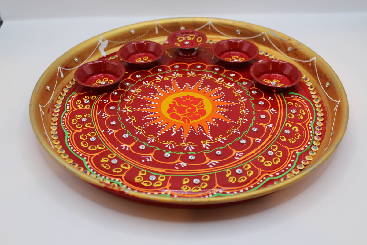 Painted steel pooja thali, red and gold with Ganesh centre and katoris – close-up