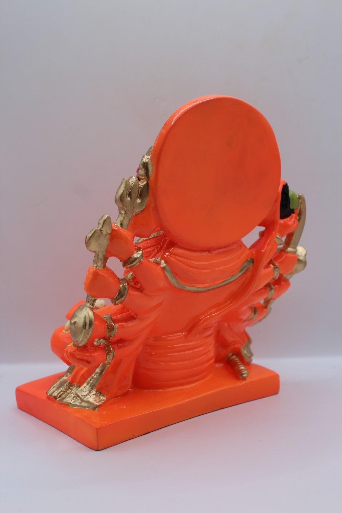 Orange resin Panchmukhi Hanuman murti, seated, back view