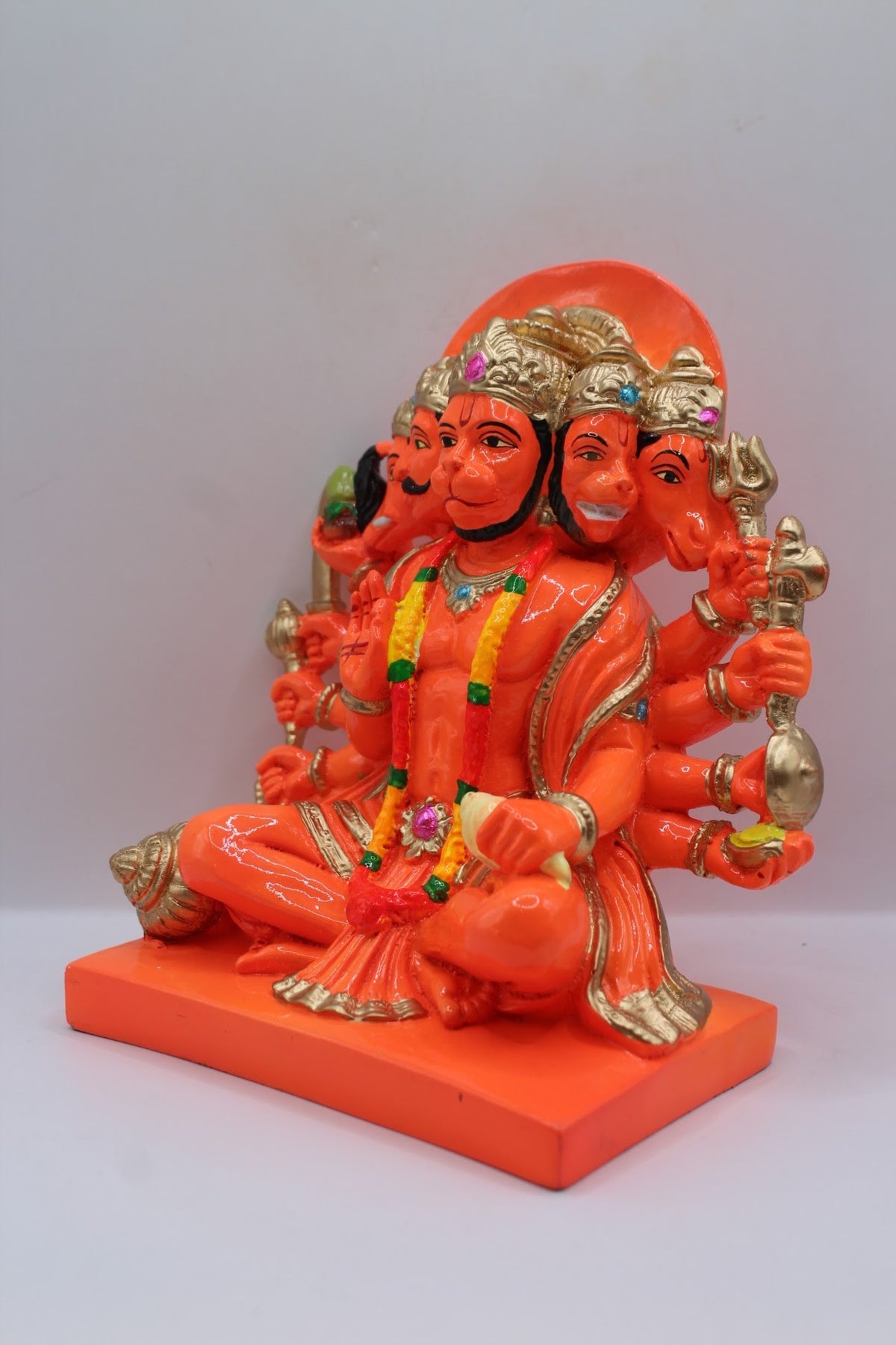 Orange resin Panchmukhi Hanuman murti, seated, right side view