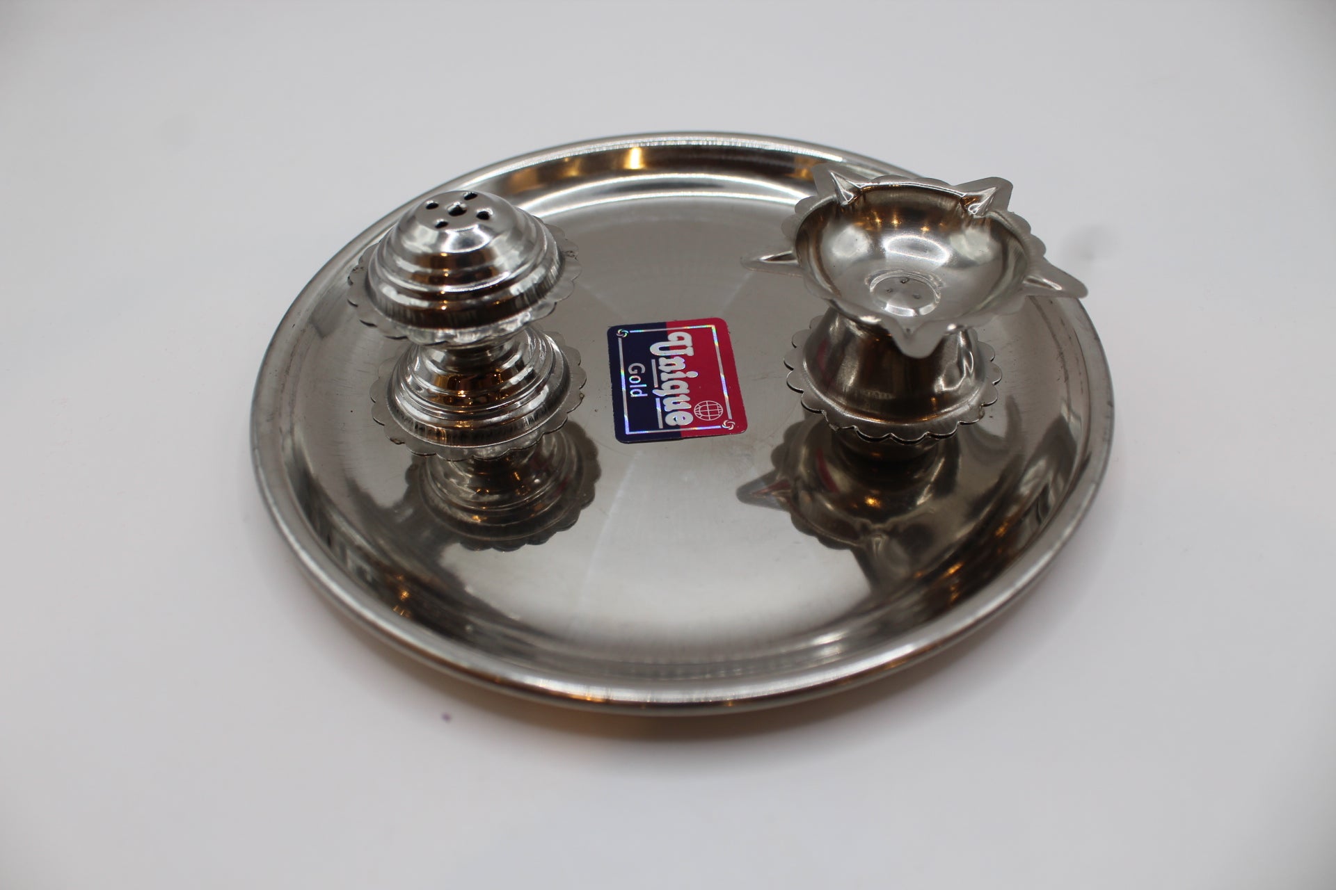 Small stainless steel pooja thali set, angled view