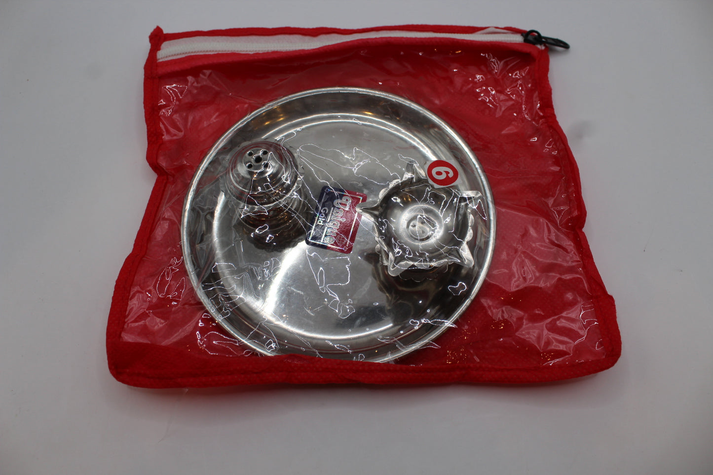 Small stainless steel pooja thali set, side profile showing depth