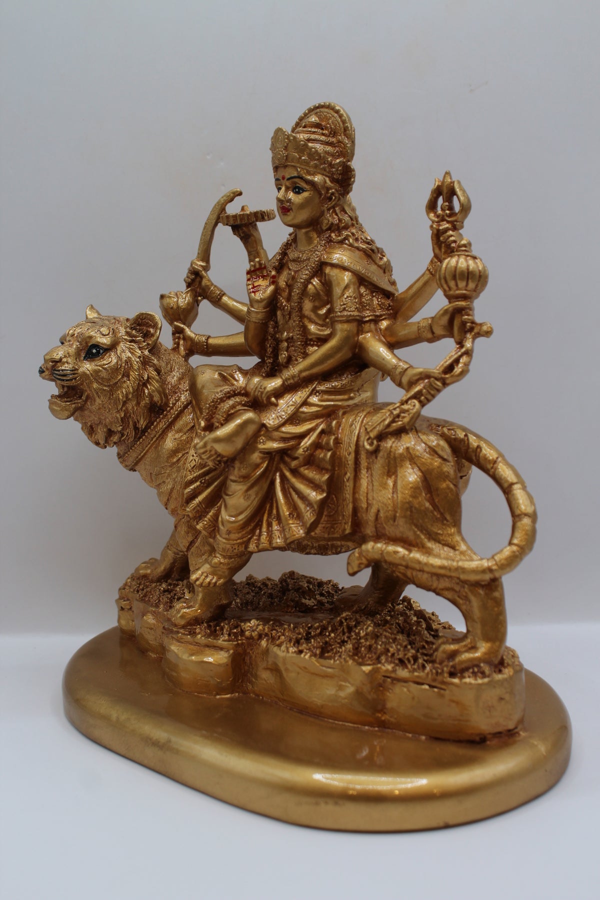 Resin Ambe Maa statue, golden finish, seated on lion, right side view