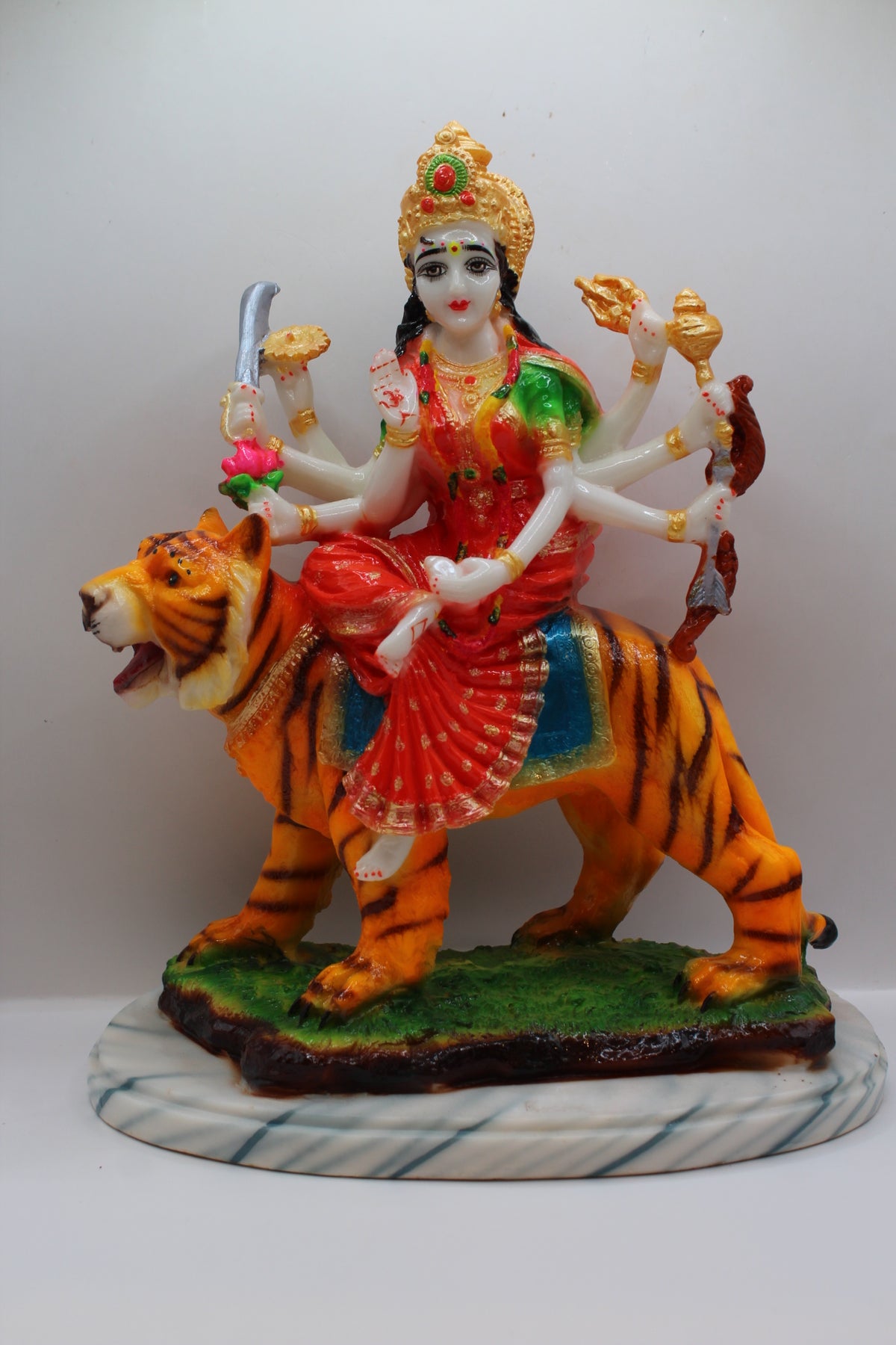 Resin Ambe Maa statue, red dress on tiger, green base, front view