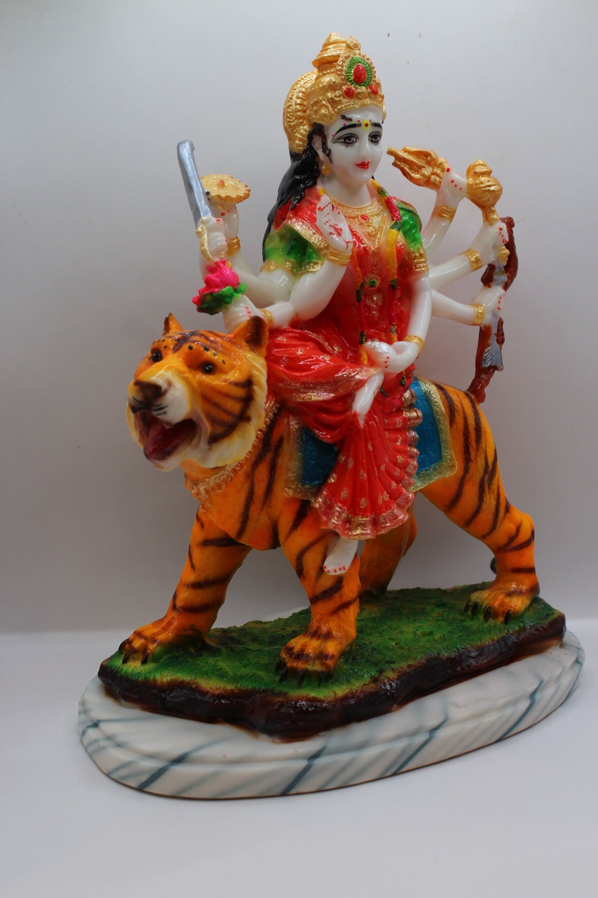 Resin Ambe Maa statue, red dress on tiger, green base, left side view