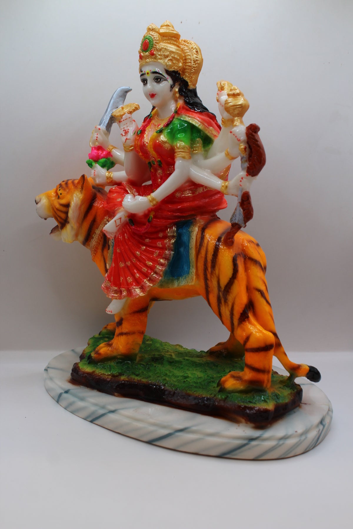 Resin Ambe Maa statue, red dress on tiger, green base, right side view