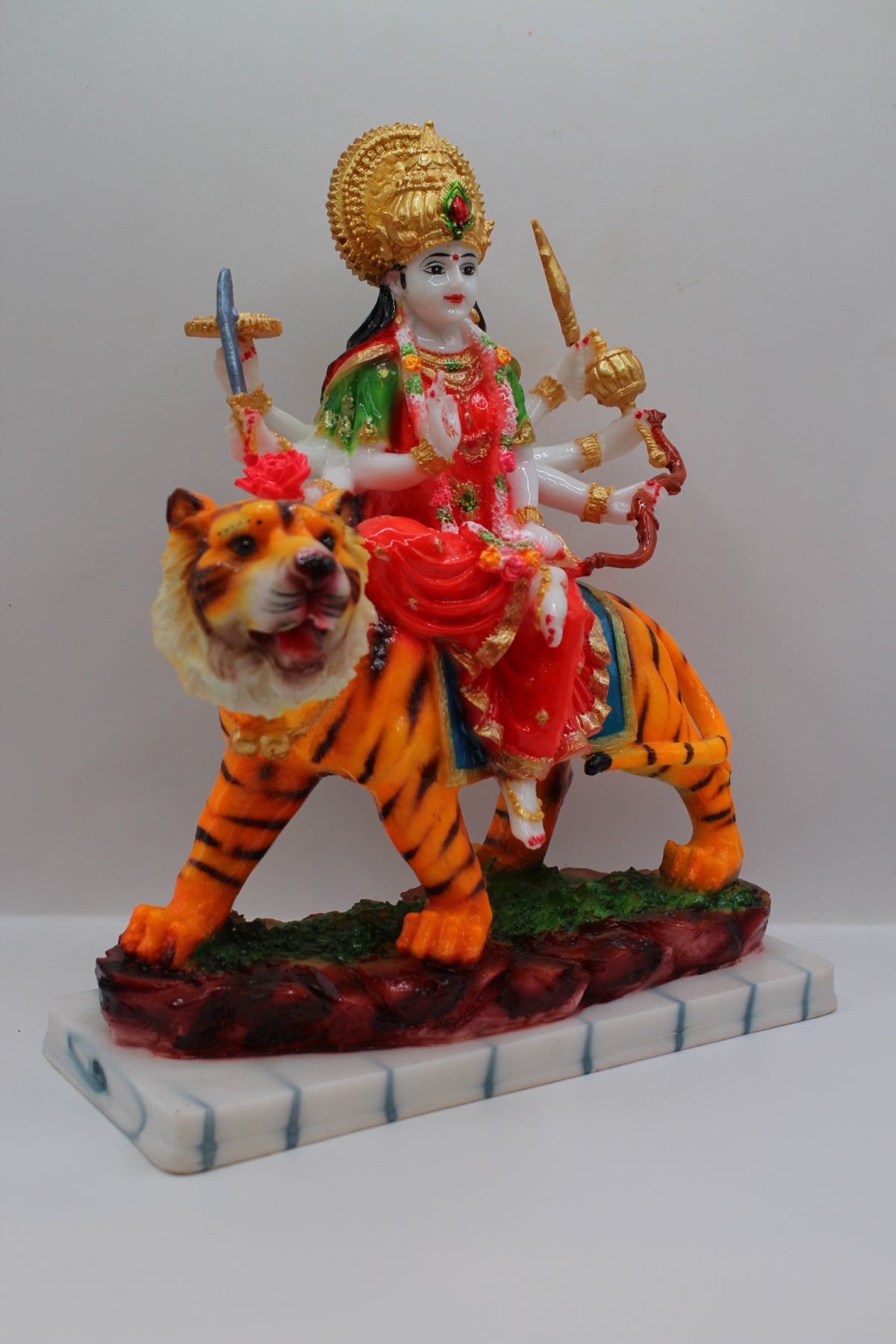 Resin Ambe Maa statue, red dress on tiger, white base, left side view