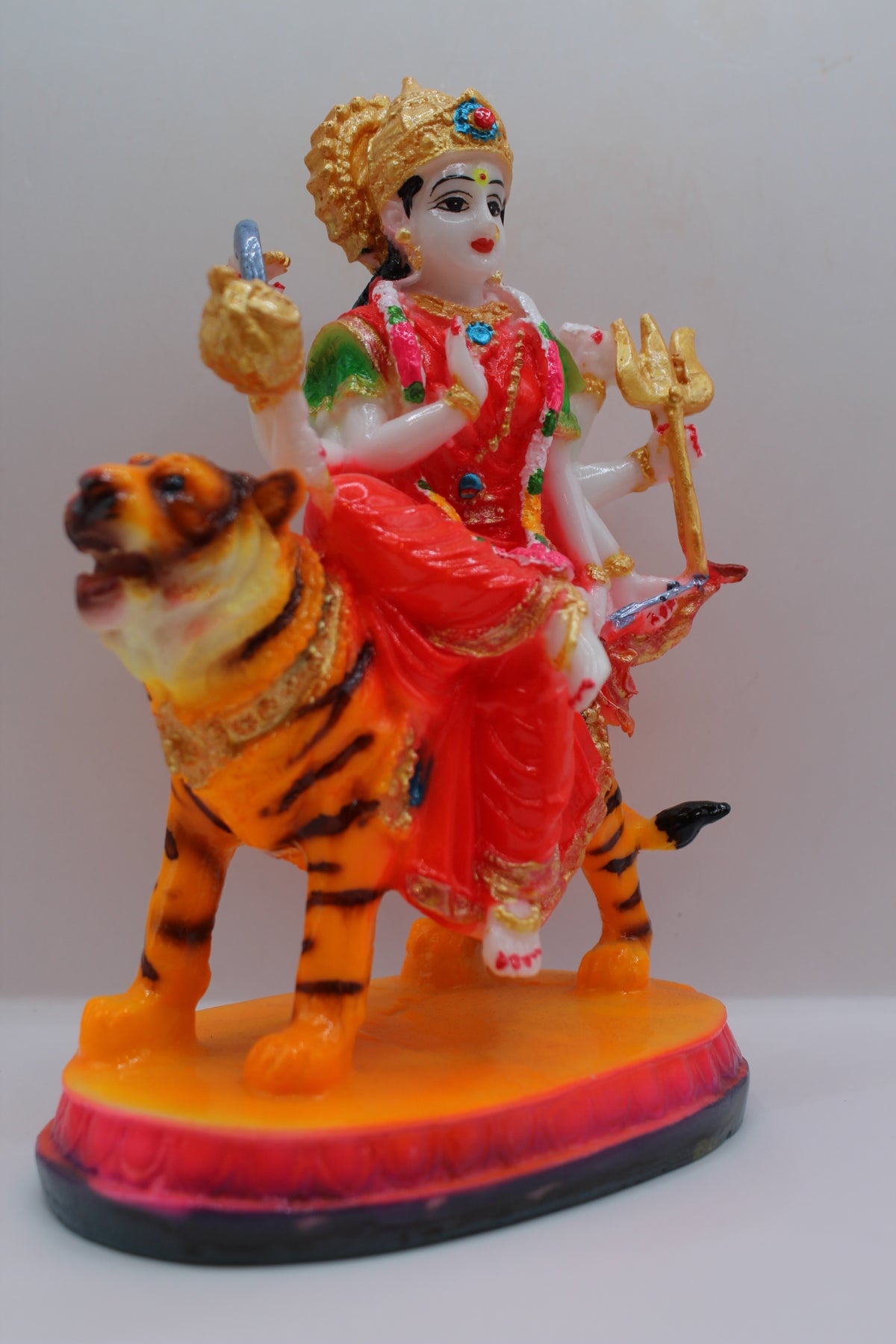 Resin Ambe Maa statue, red dress, seated on tiger, left side view