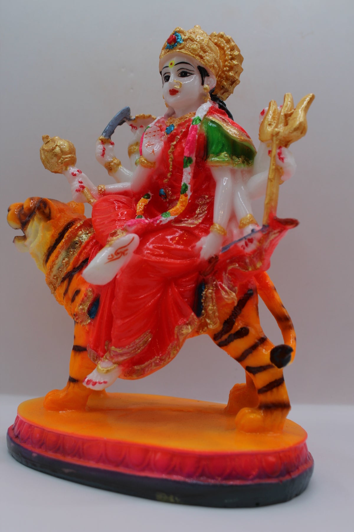 Resin Ambe Maa statue, red dress, seated on tiger, right side view