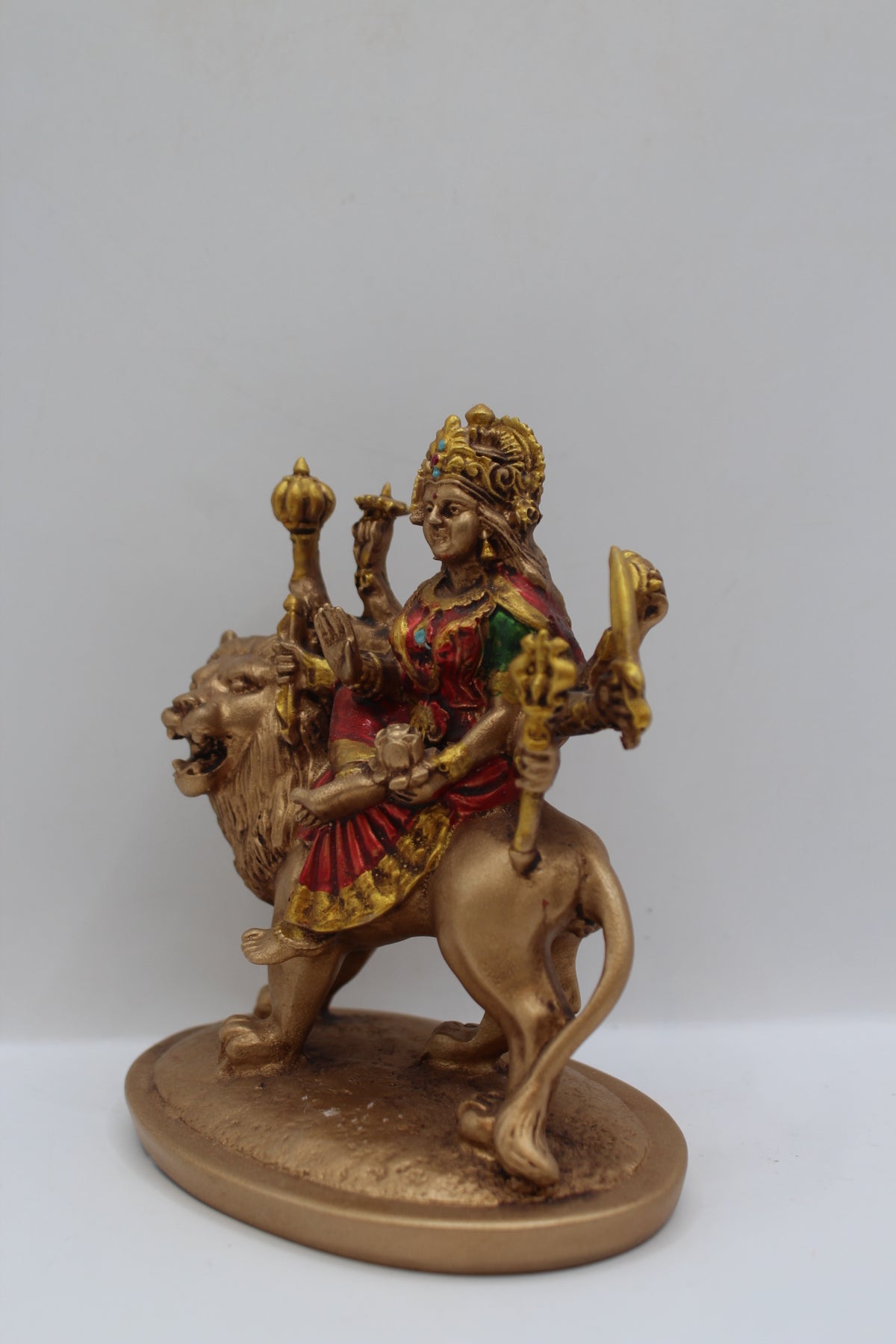 Resin Ambe Maa statue, seated on lion, antique bronze, right side view