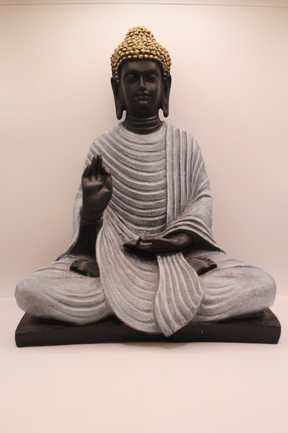 Charcoal grey resin Buddha statue on black base, front
