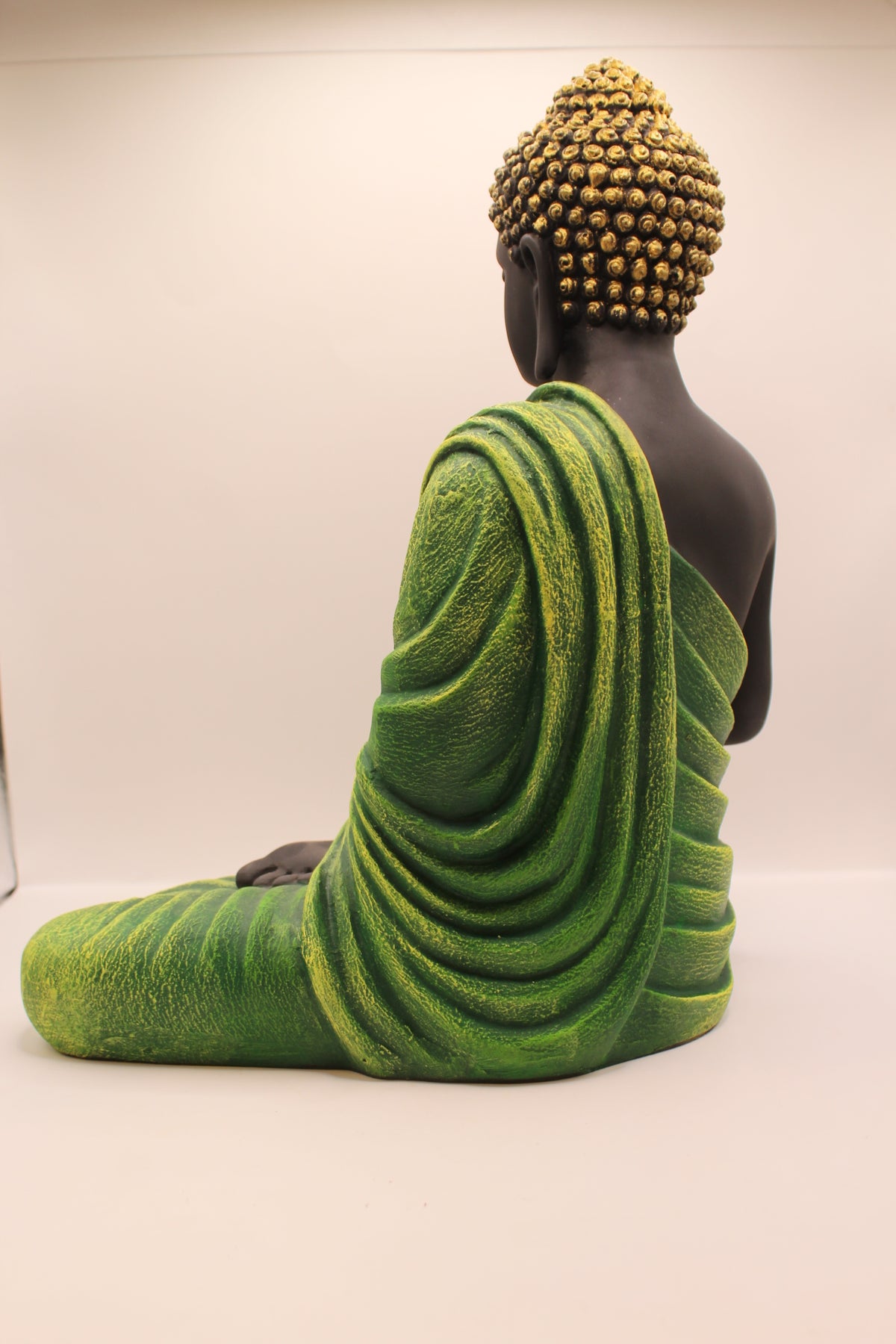 Forest green Buddha statue, back