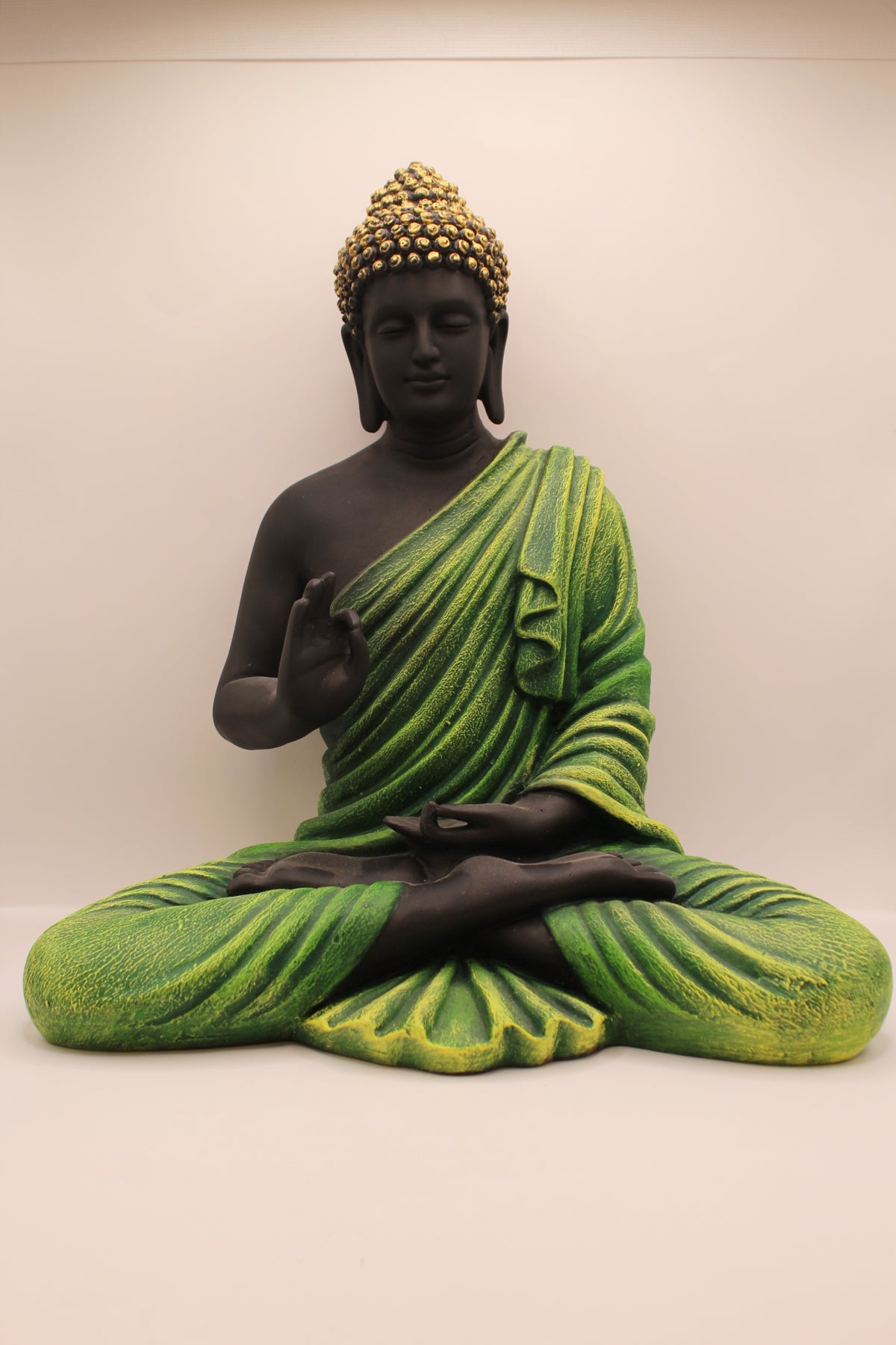 Resin Buddha statue with forest green robe and black body, front