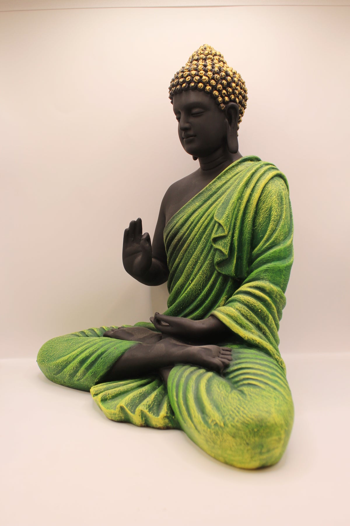 Forest green Buddha statue, right side