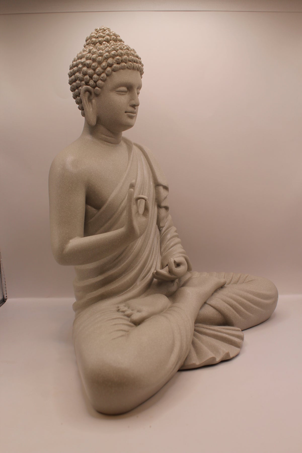 Grey Buddha statue, left side